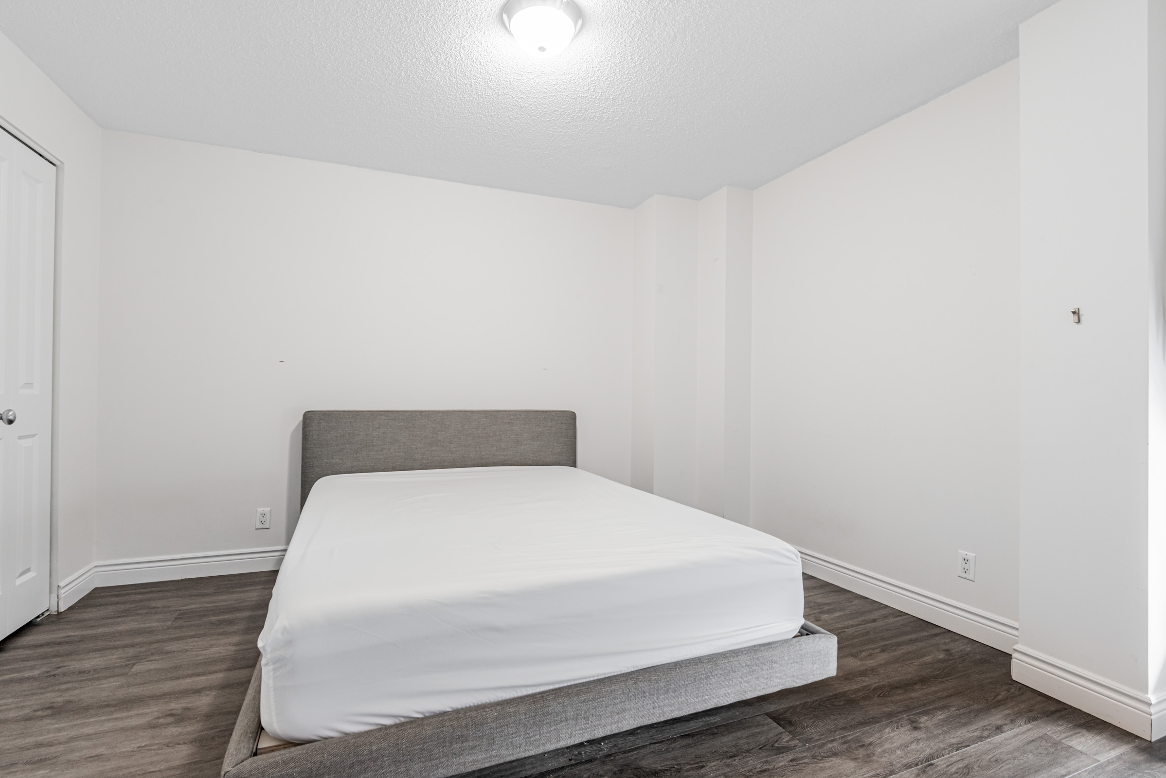 11 St Joseph St Unit 311 spacious second bedroom with large bed.
