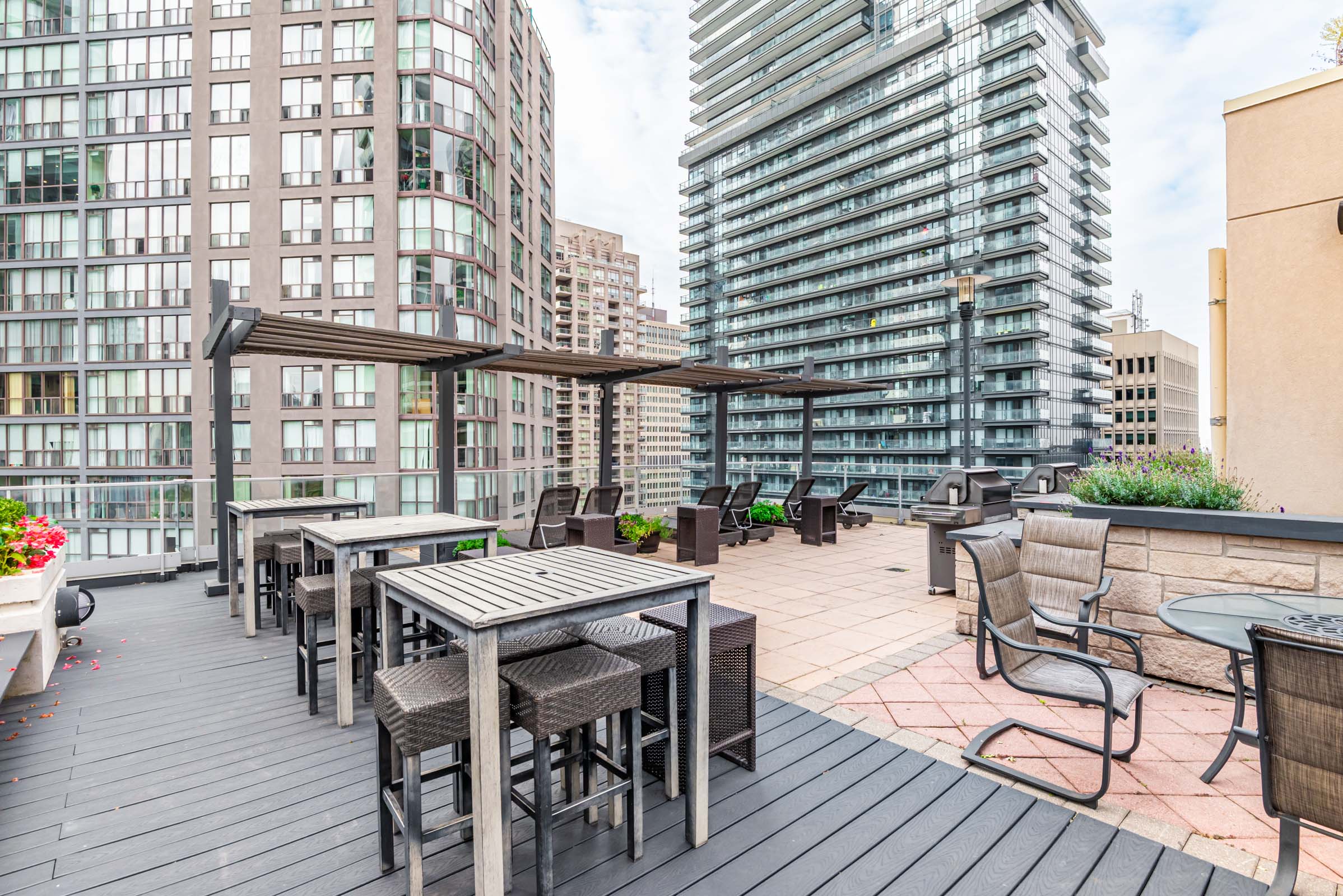 11 St Joseph St rooftop terrace with patio furniture showing view of downtown Toronto.