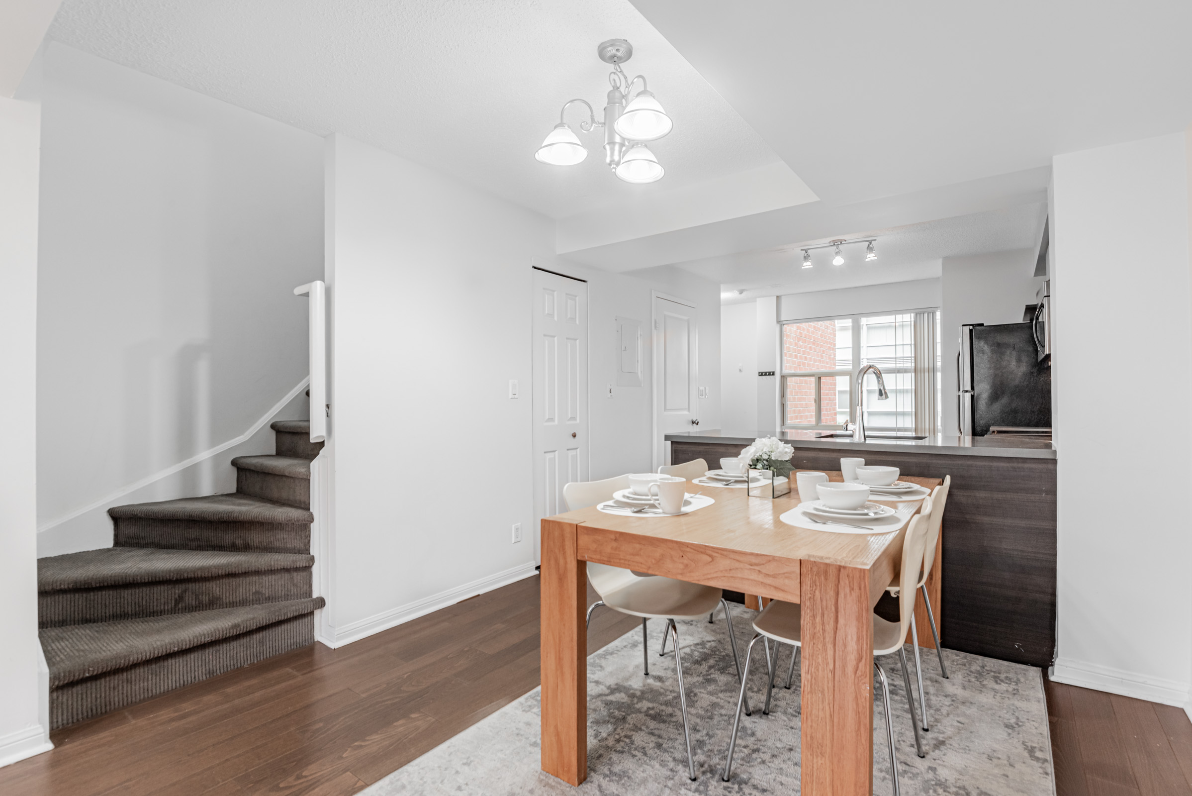 11 St Joseph St Unit 311 condo dining room and kitchen area with stairs.