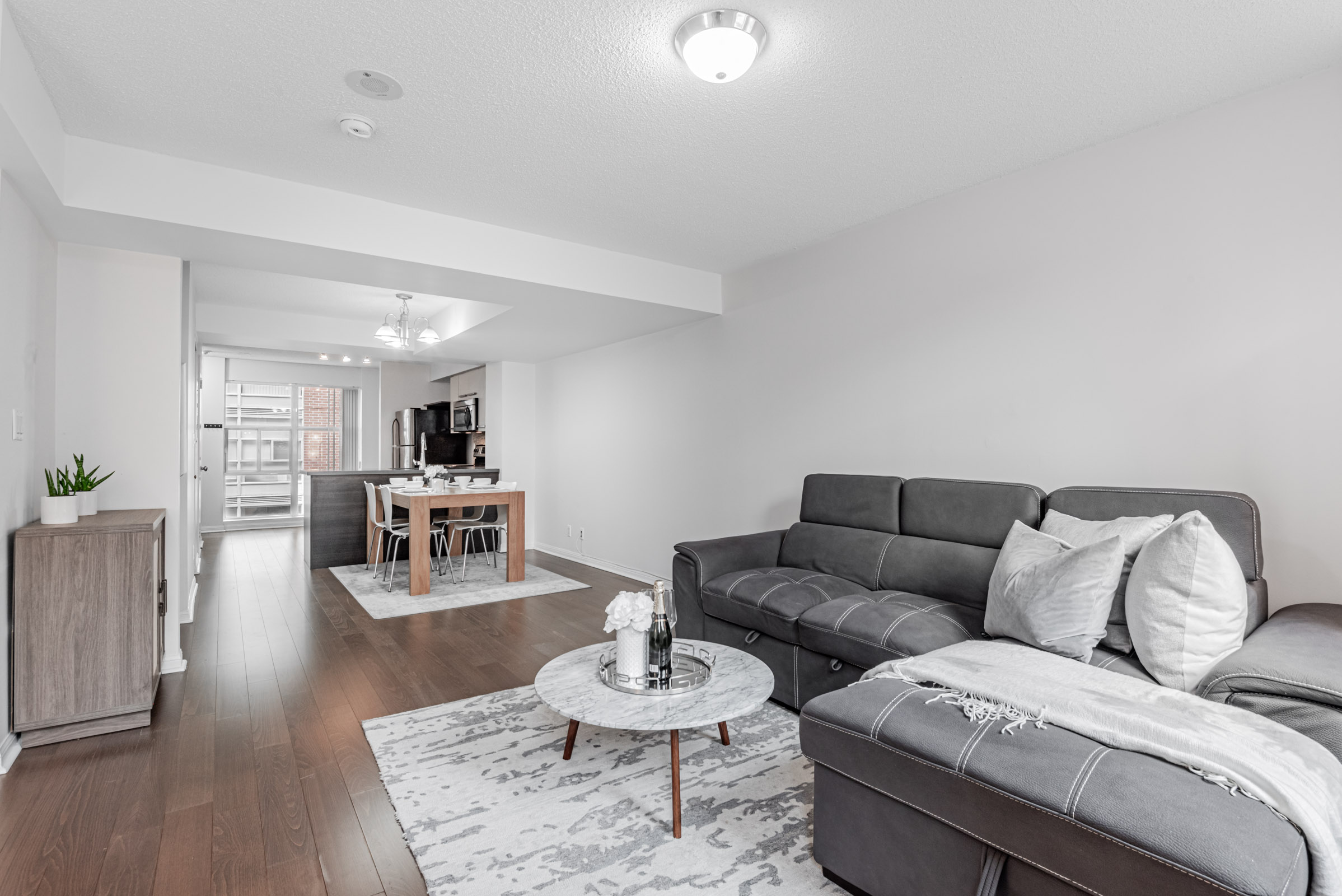 11 St Joseph St Unit 311 open-concept dining room with dining table and chairs.