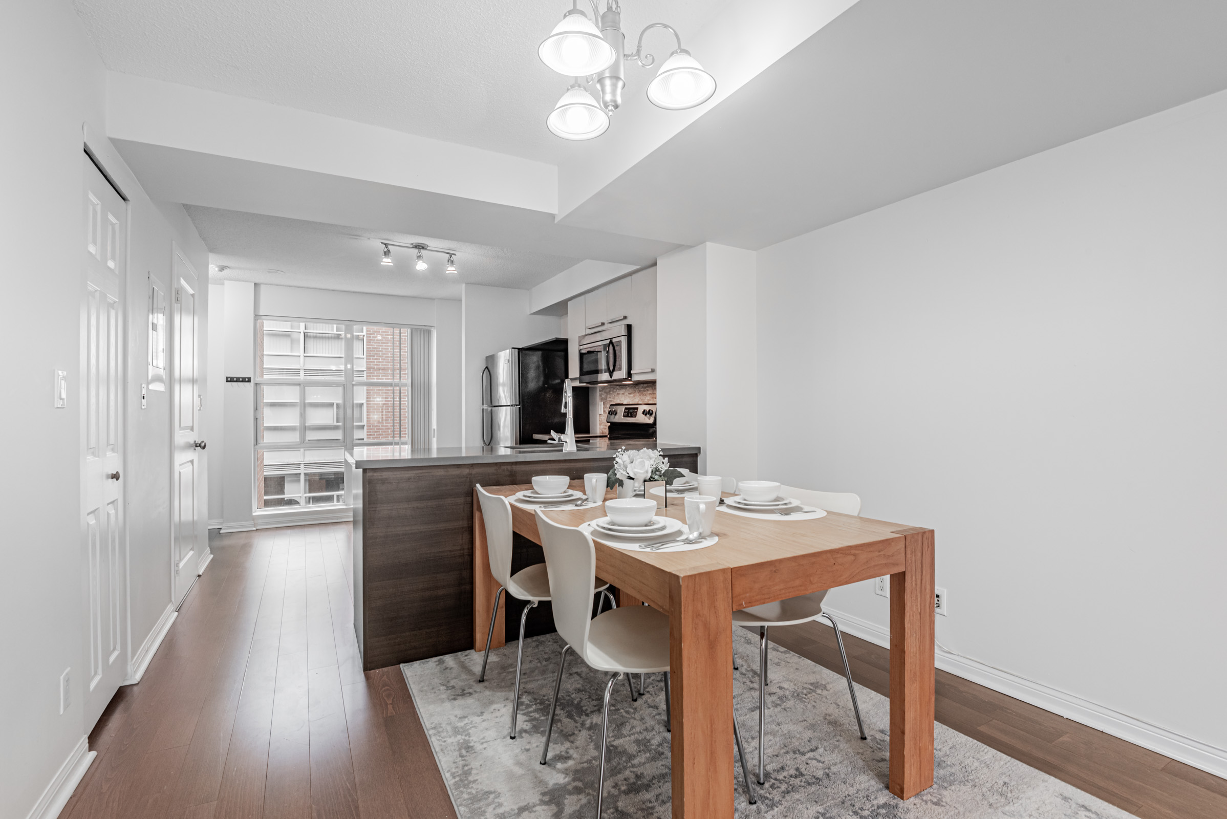 11 St Joseph St Unit 311 dining room next to kitchen with large, floor-to-ceiling windows.
