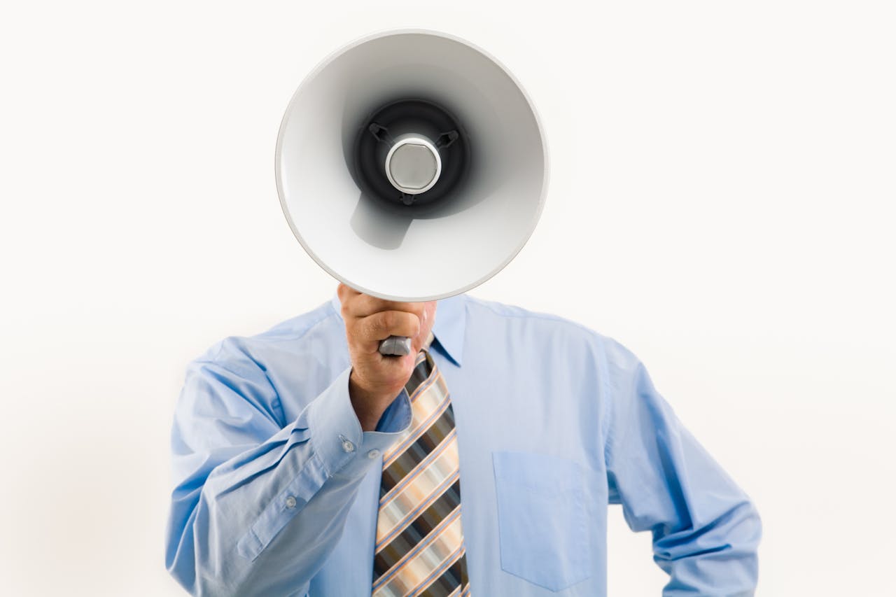 Photo of faceless man with megaphone to show upcoming interest rate announcement.