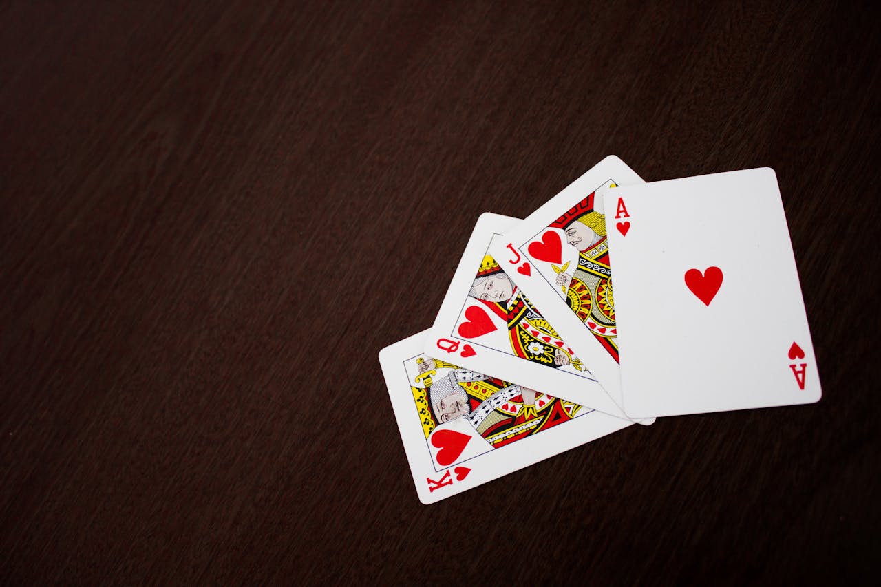 Playing cards on table showing royal flush.