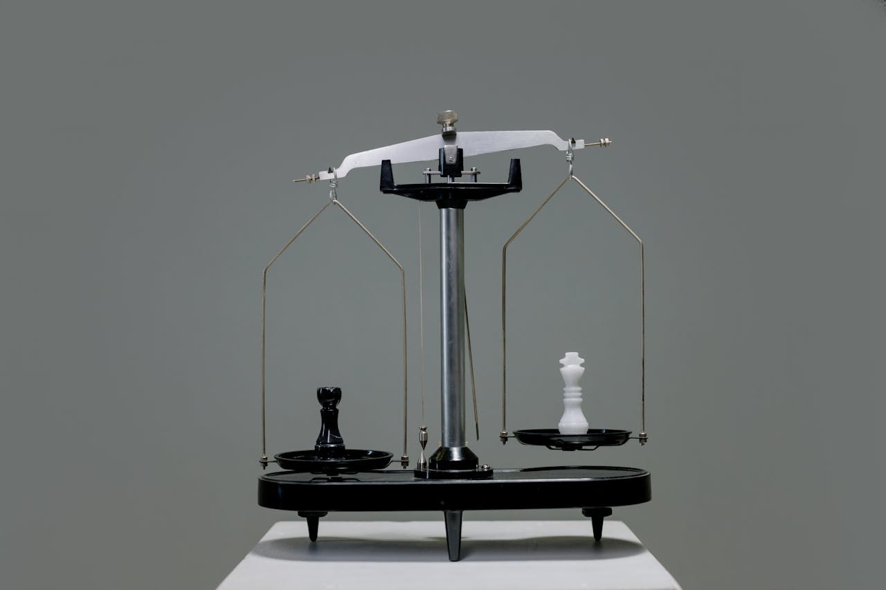 2 chess pieces in scales to show balance of power in August 2025 housing market.