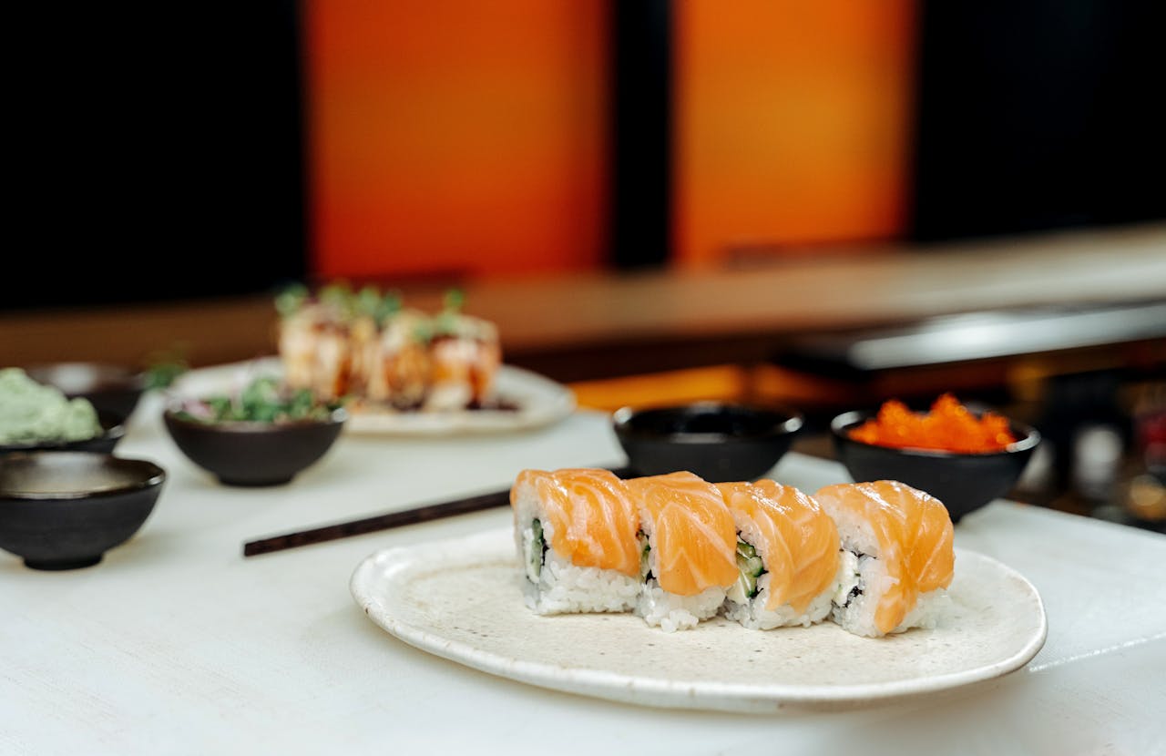 Sushi restaurant with plates of sushi on white table.