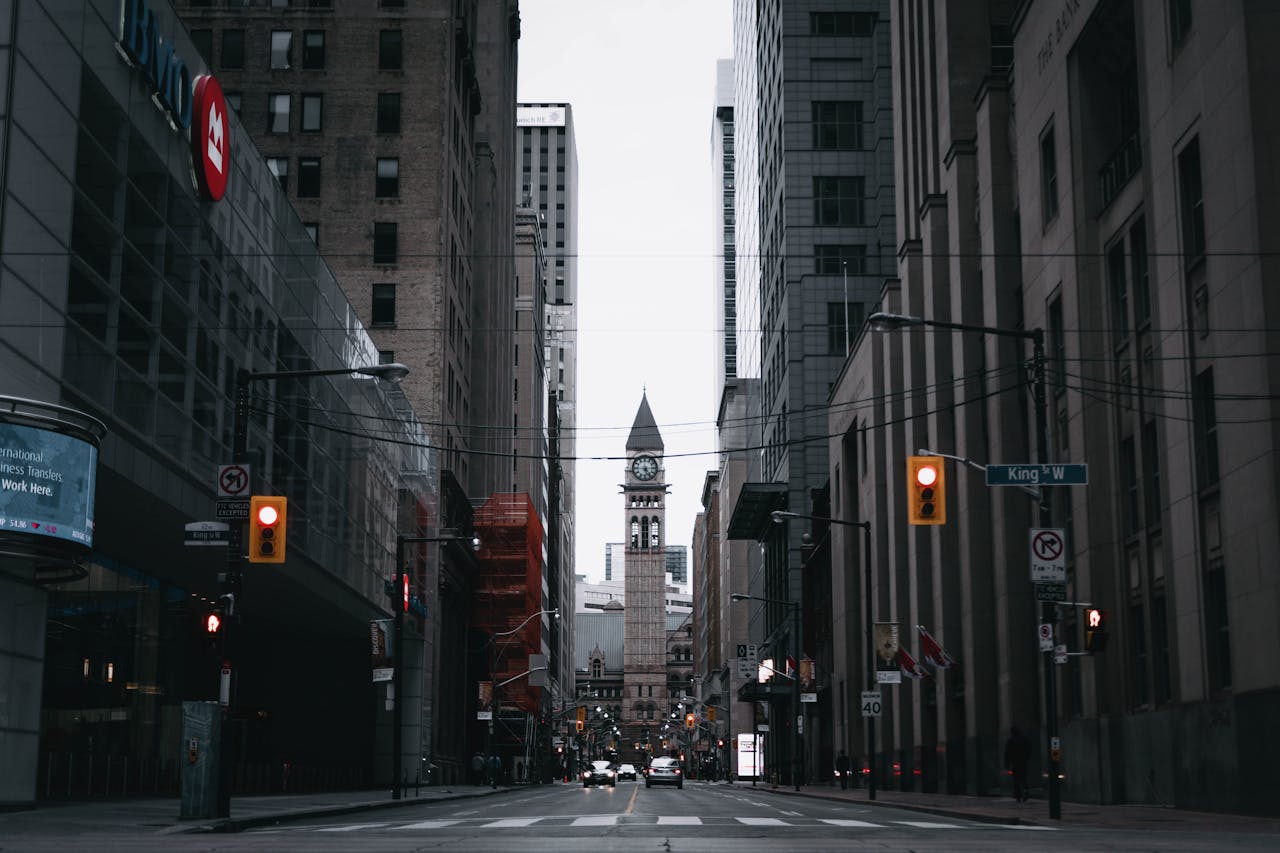 Street level view of clock tower in Toronto's King St to show importance of timing and September 2025 rate cut.