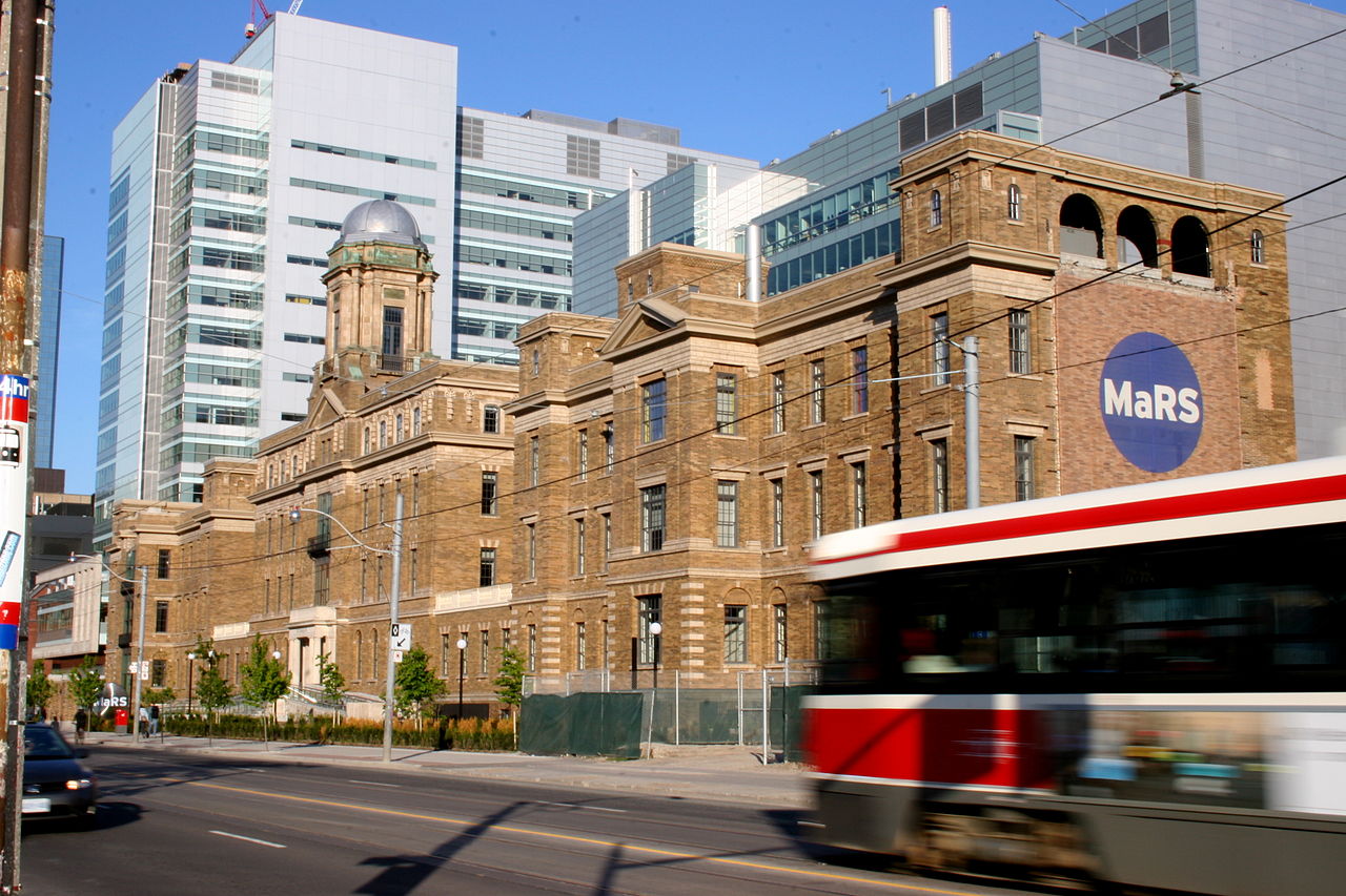 Red TTC Toronto streetcar in front of MaRS Discovery District building.
