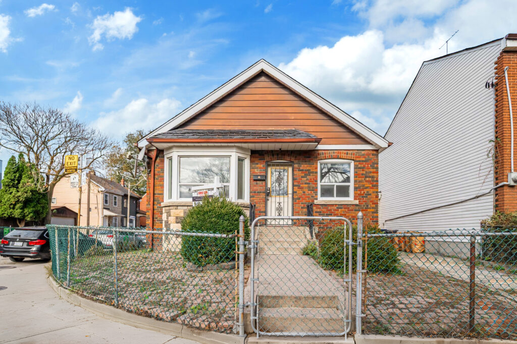 Front of 42 Carr St with green wire fence.