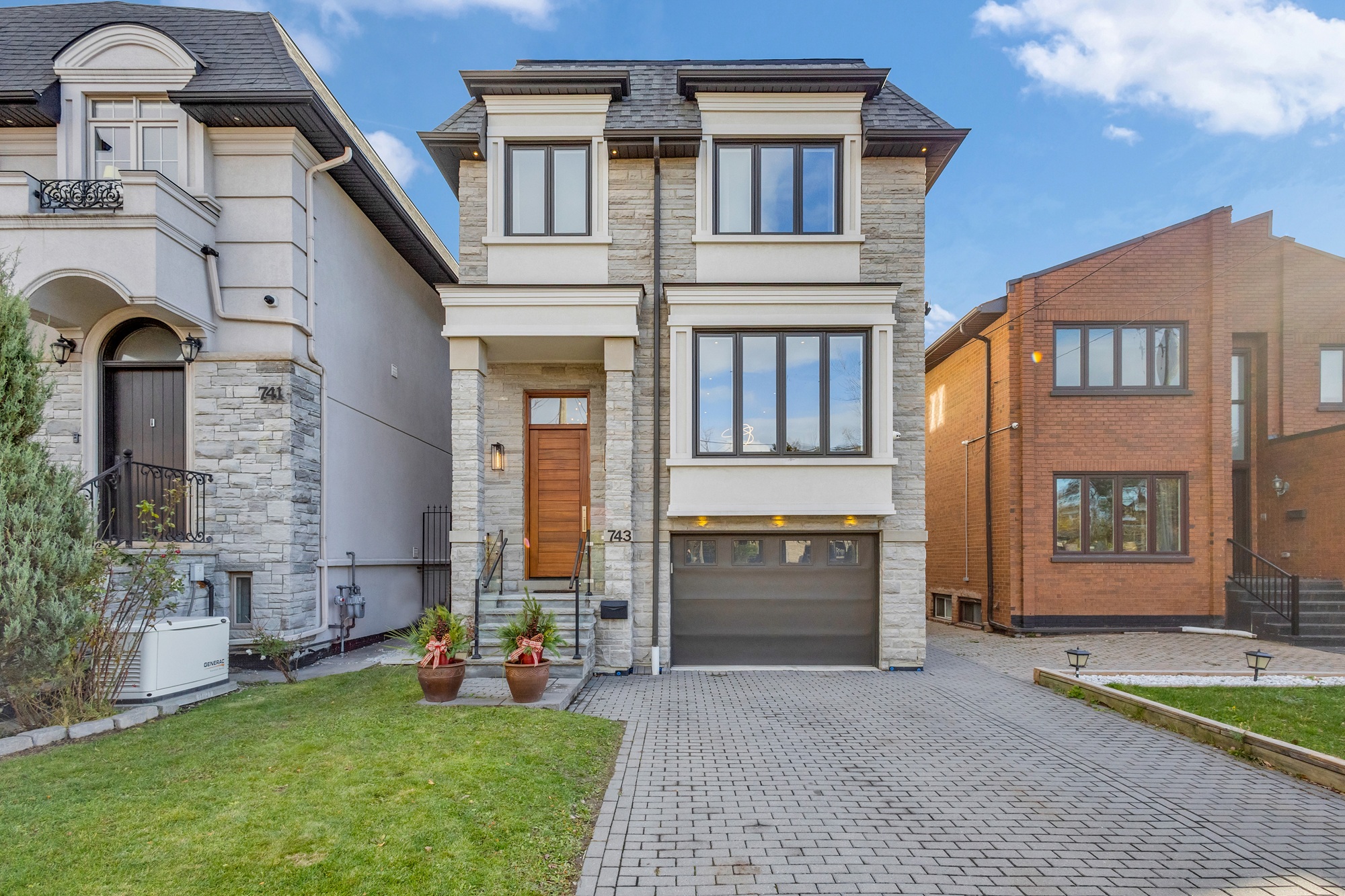 Front shot of 743 Glencairn Ave, a 2-storey detached house with clean lines and gray-stone exterior.