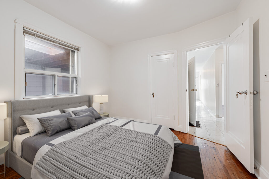 42 Carr St large primary bedroom with 3D-rendered bed, hardwood floors, closet and window.