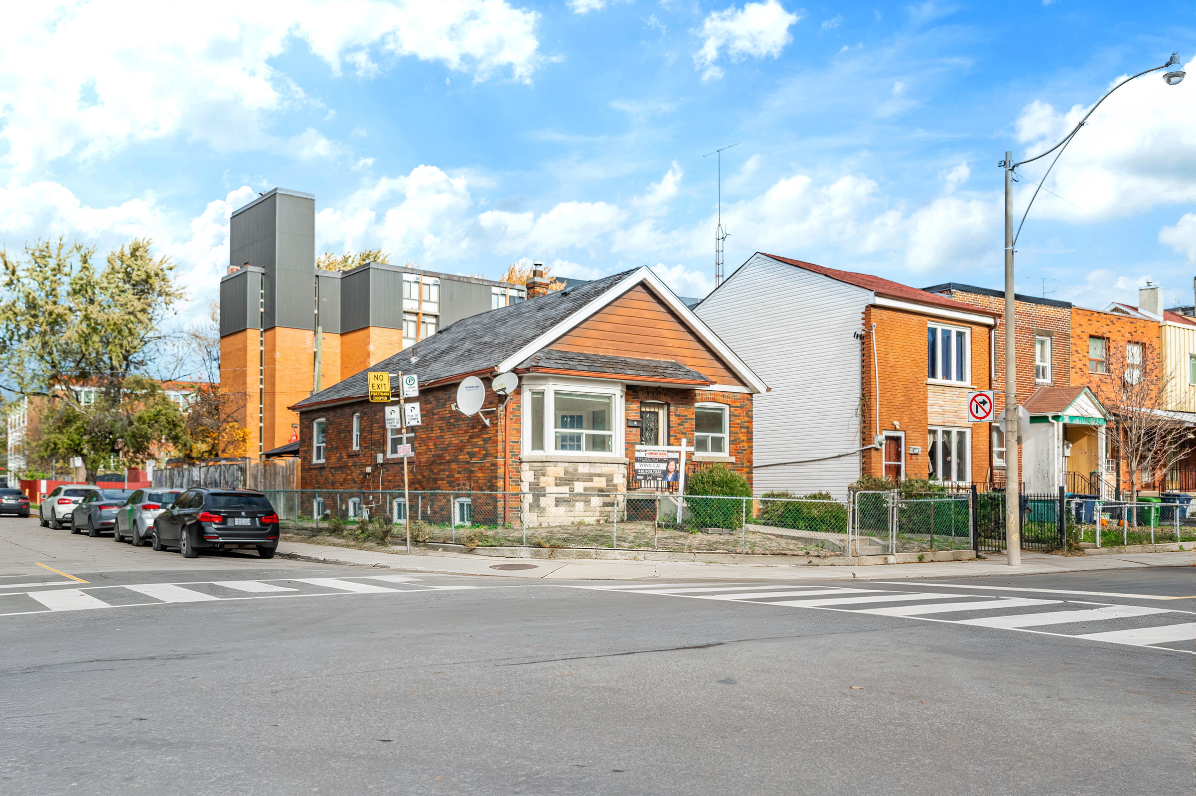 Across the street view of 42 Carr St, with parked cars on left and houses on right.