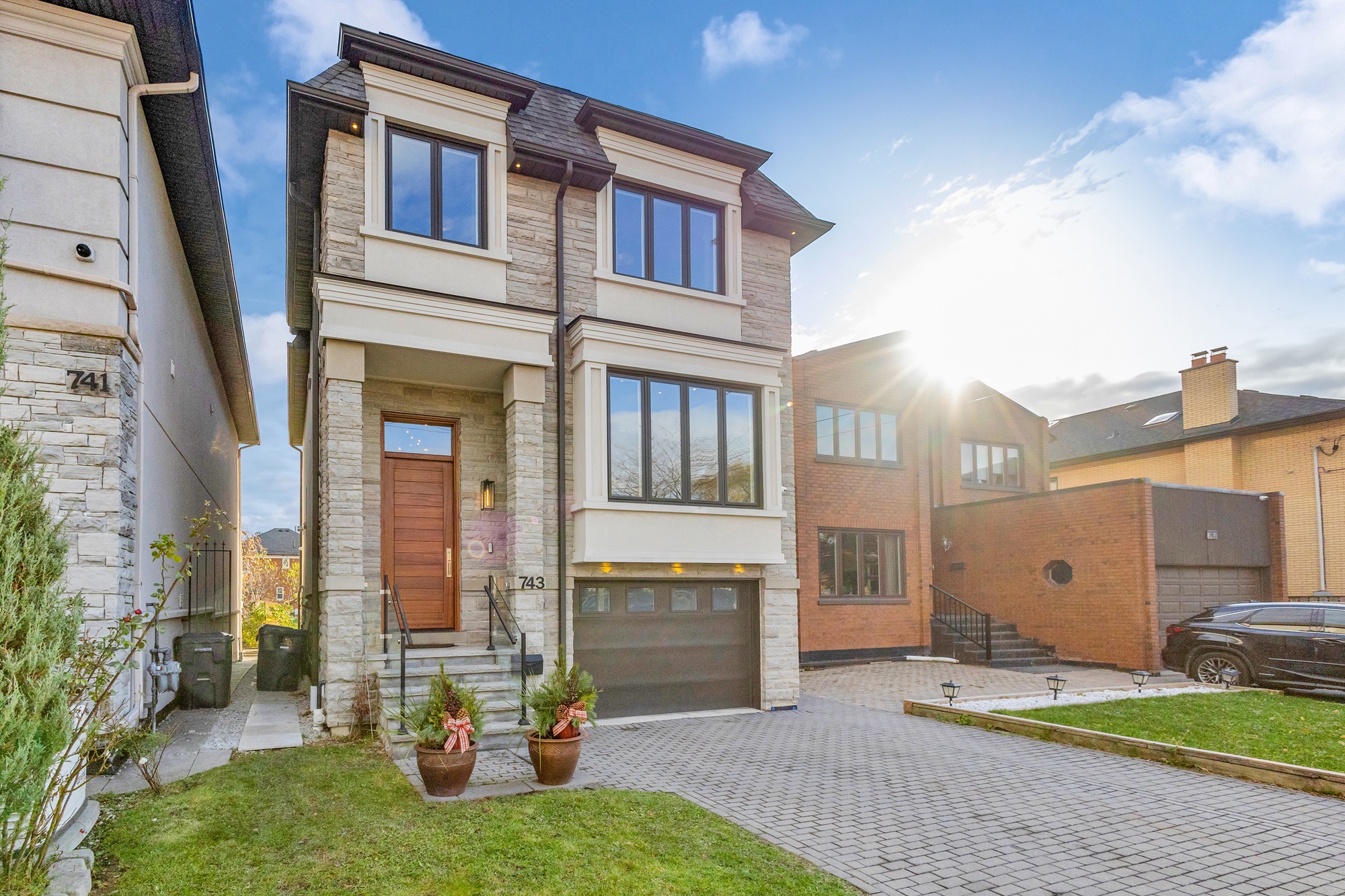 Side view of 743 Glencairn Ave's gray-stone exterior and solid wood front door. 
