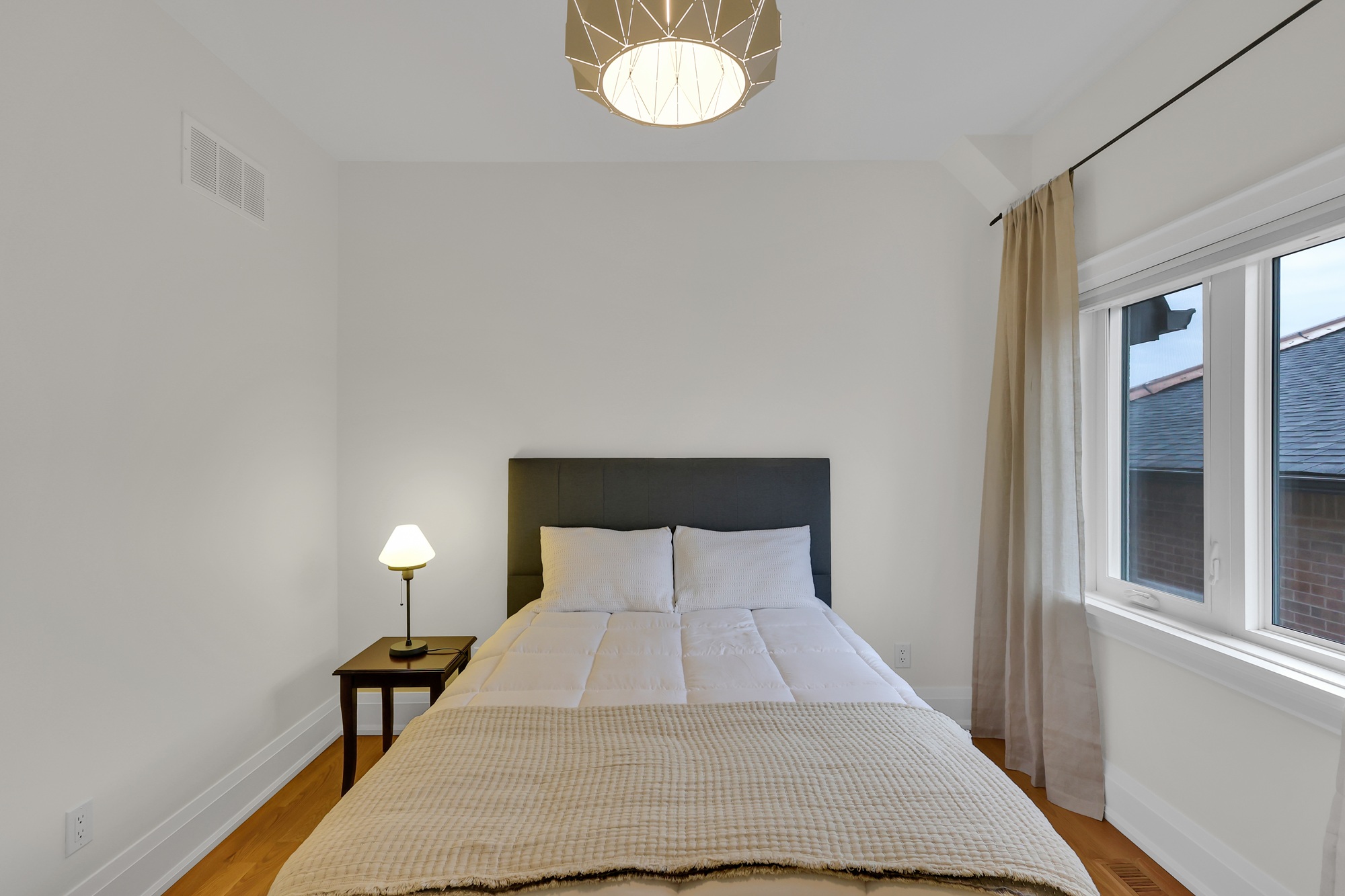 743 Glencairn Ave second bedroom with hardwood floors and windows.