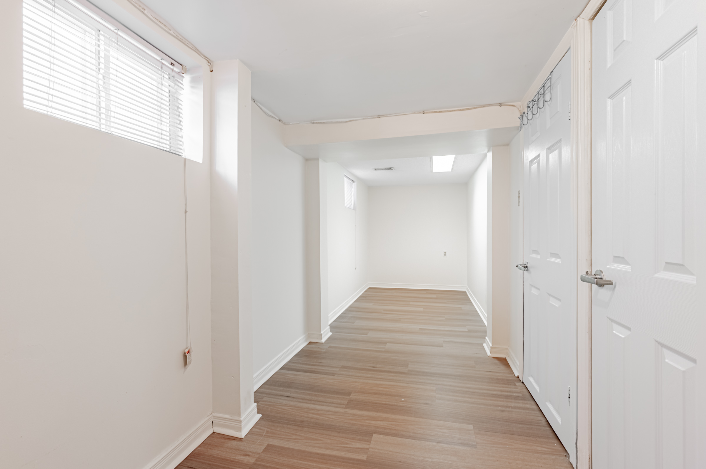 42 Carr St empty storage space with hardwood floors and windows.