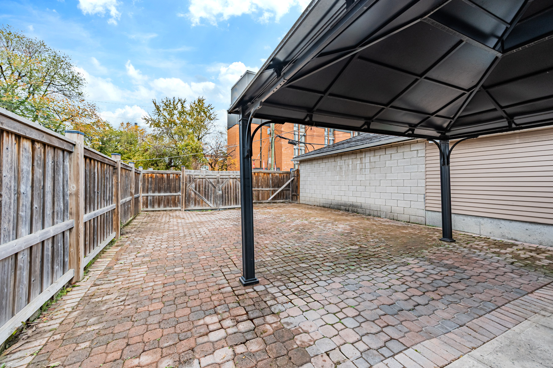 Wet backyard with dry ground under canopy.