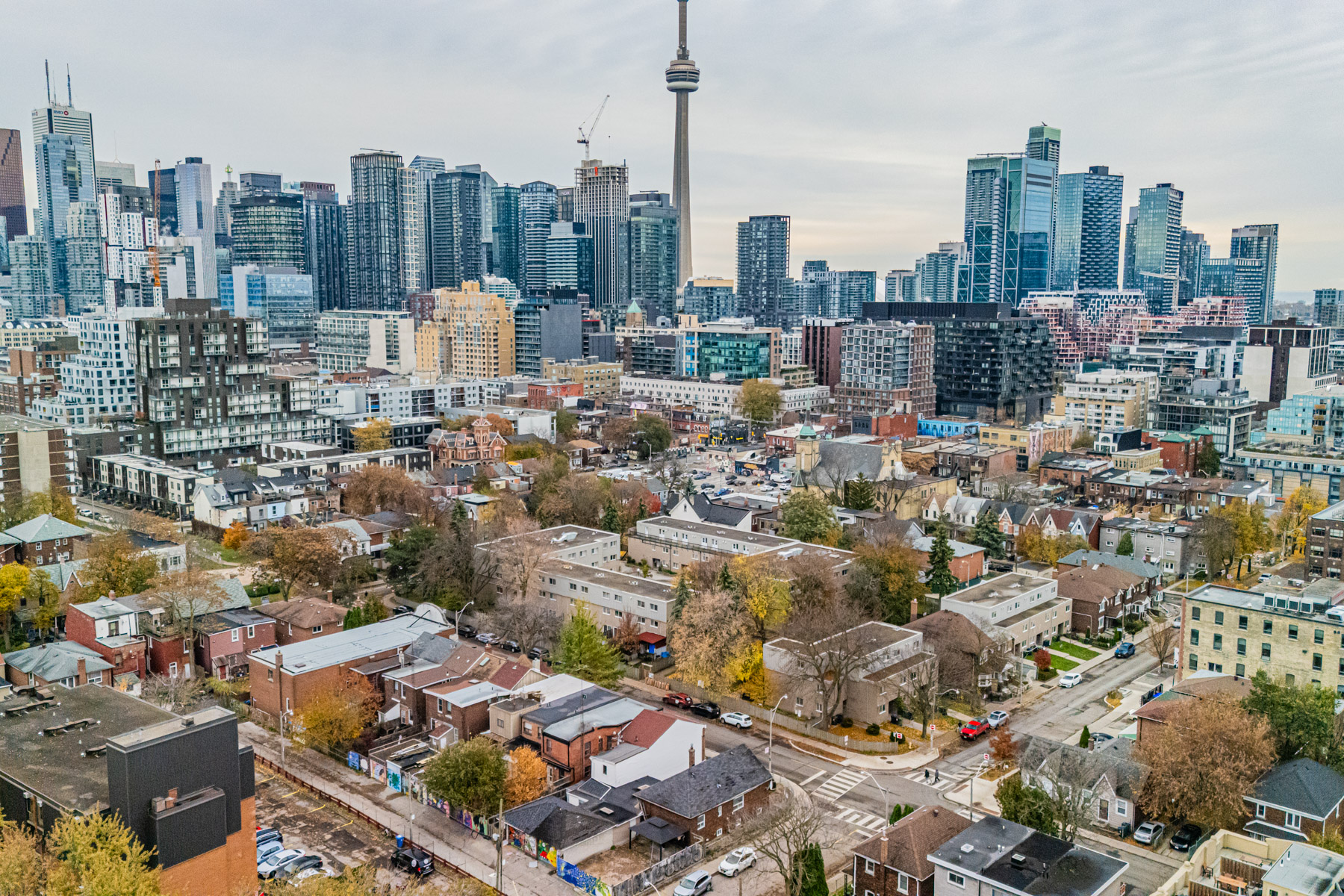 View of houses in foreground and Toronto condos and CN Tower in background.