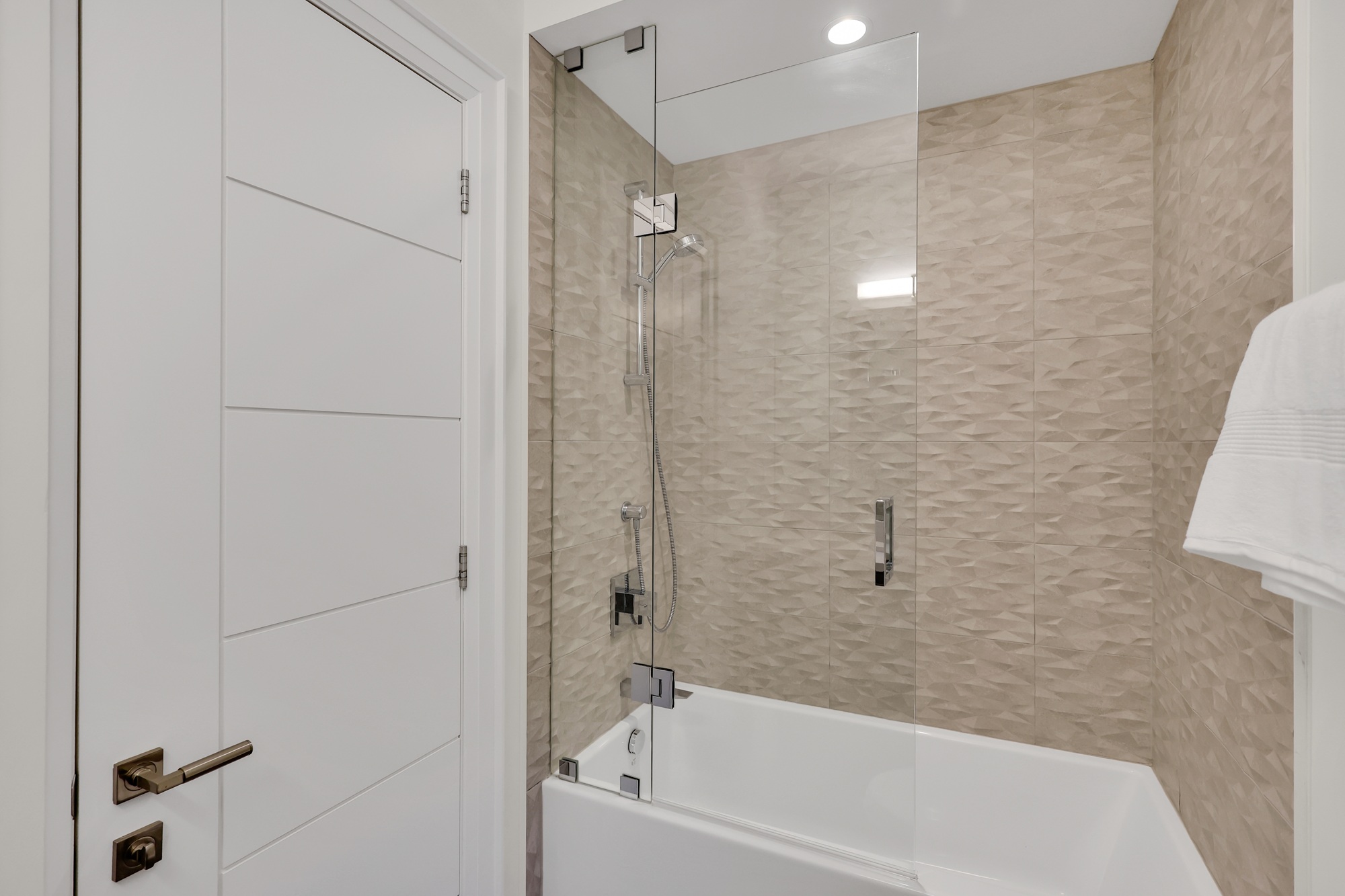 Soaker tub with sliding glass door.