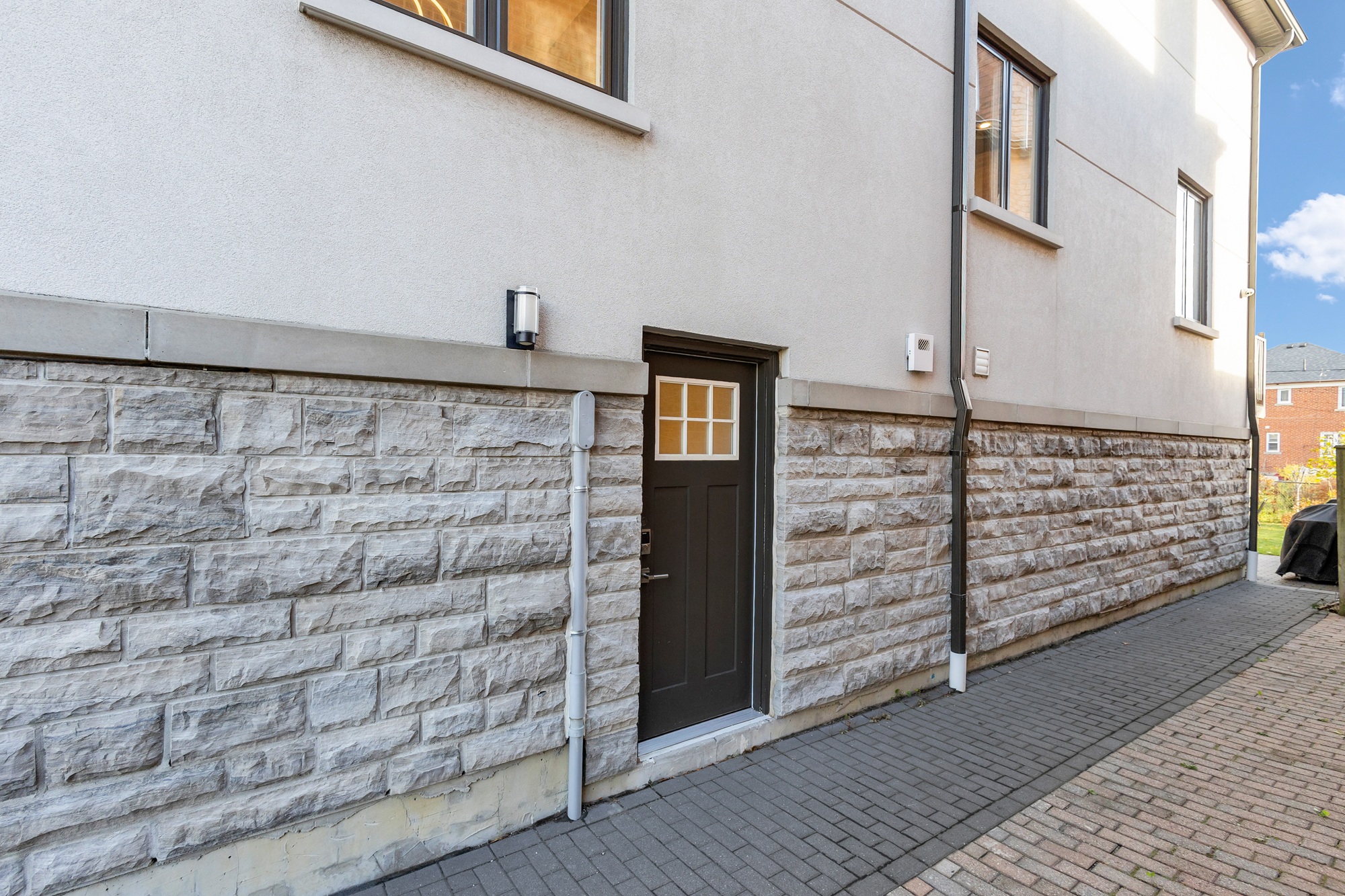 House exterior with side door private entrance to basement.