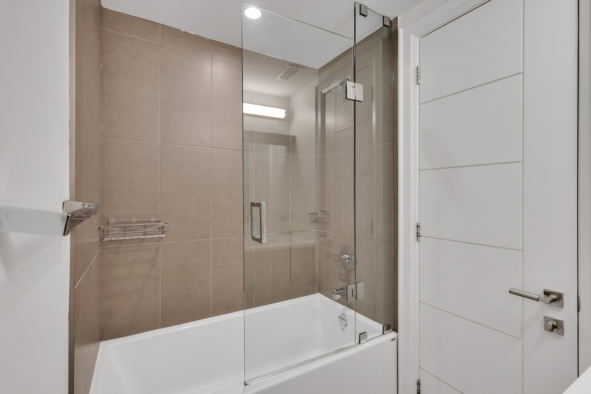 743 Glencairn Ave second basement studio unit with 4-piece ensuite bath containing soaker tub with sliding glass door.