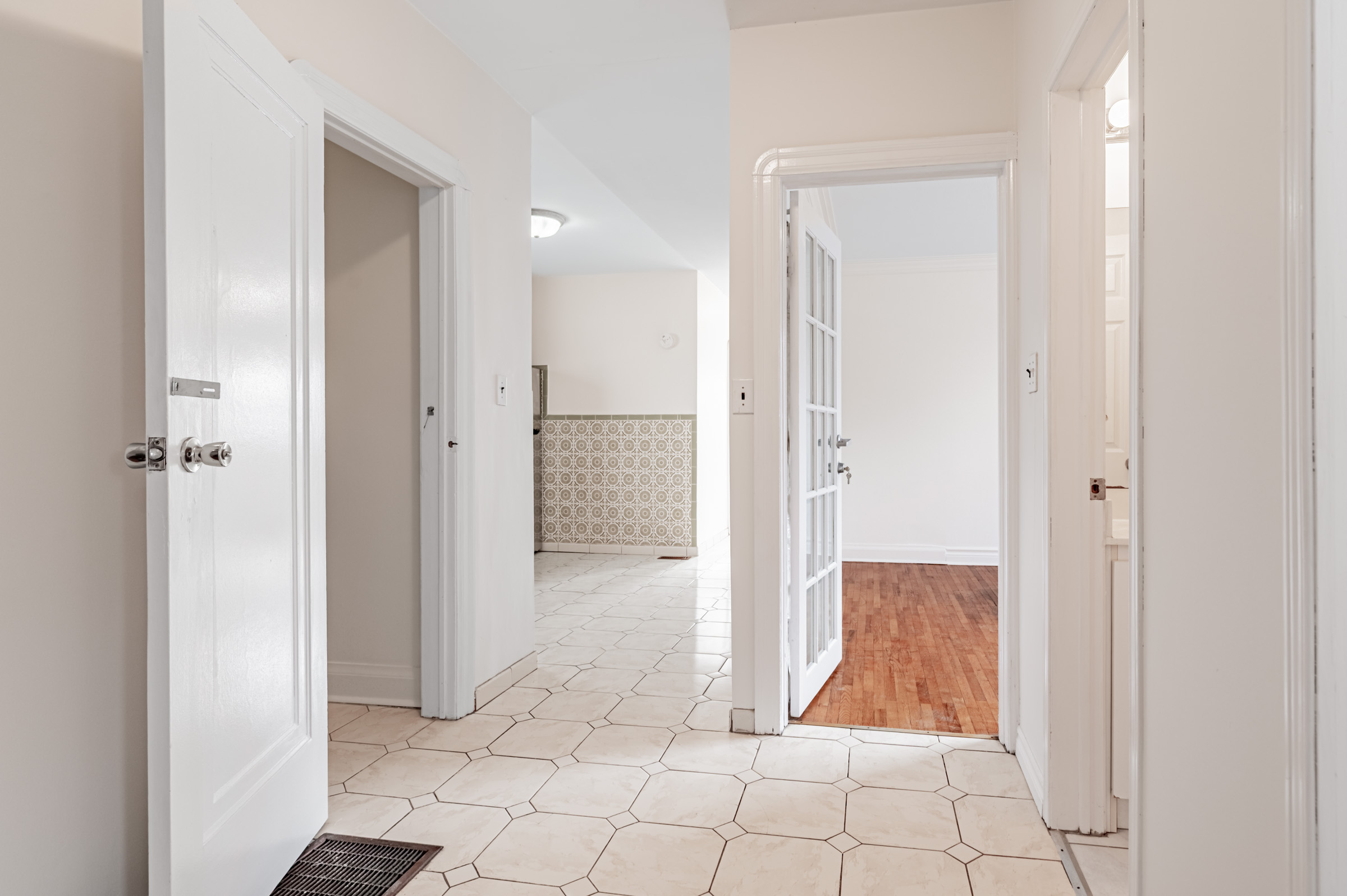 42 Carr St hallway with partial views of dining room and kitchen.