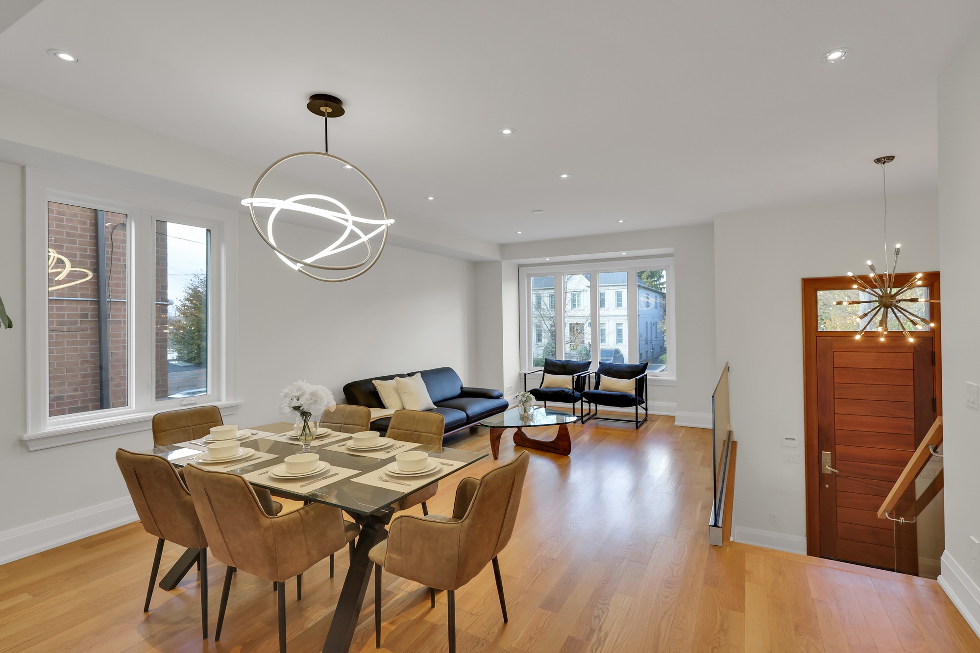 743 Glencairn Ave living and dining areas with modern chandeliers and pot-lights. 