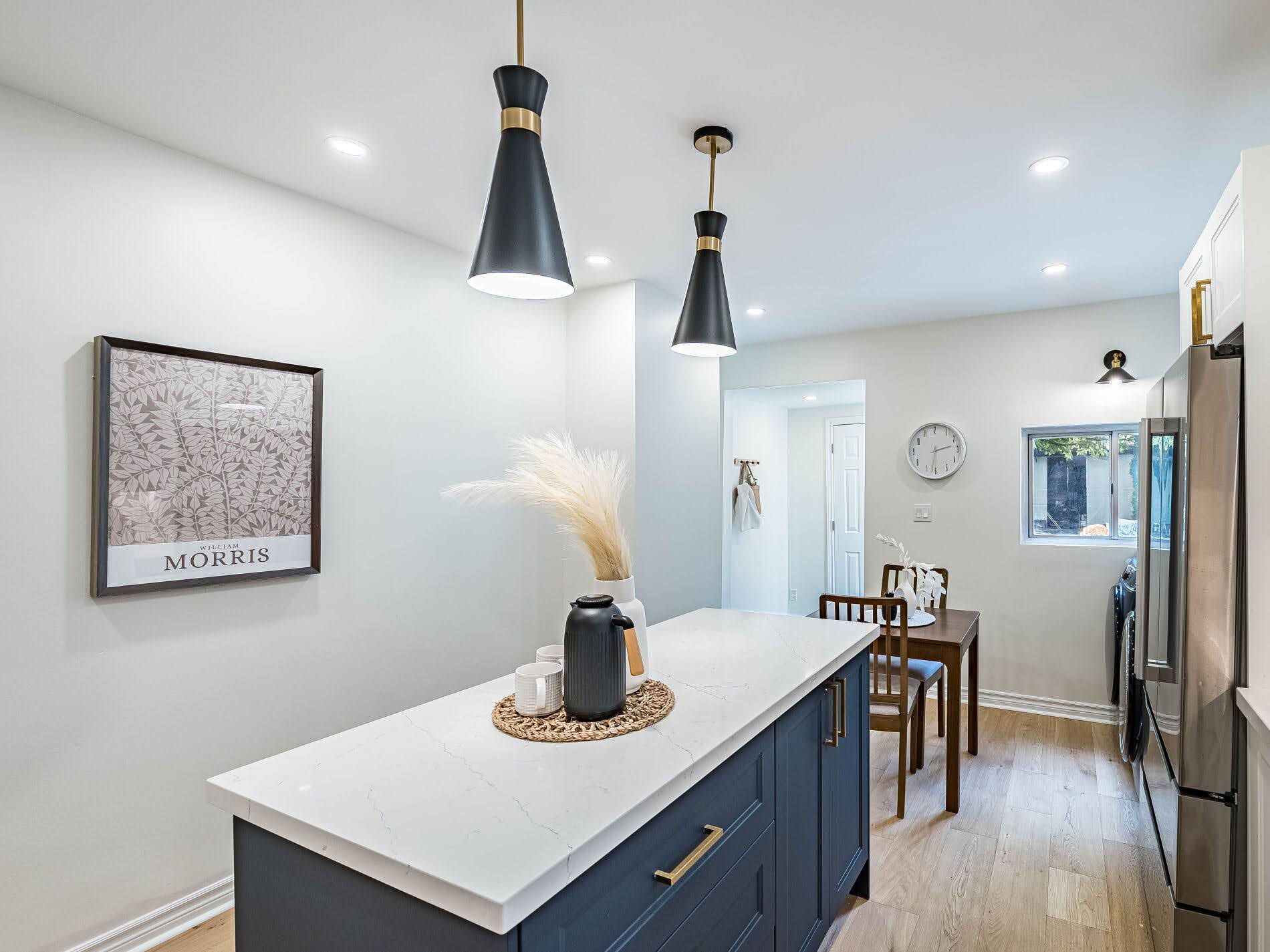 Two-tone kitchen island with white surface and dark blue cabinets.