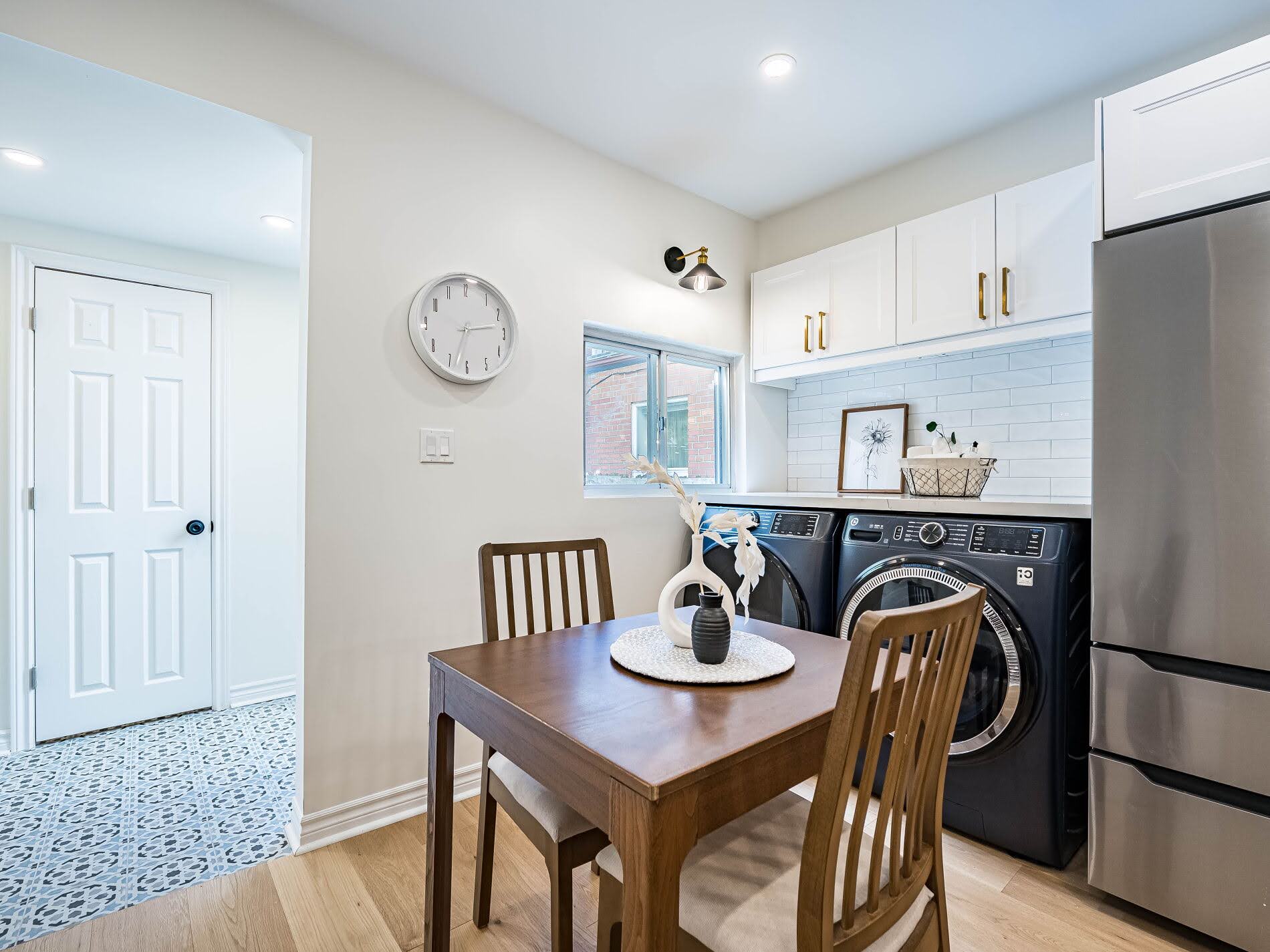 Kitchen with dining table and laundry area - 918 Ossington Ave.