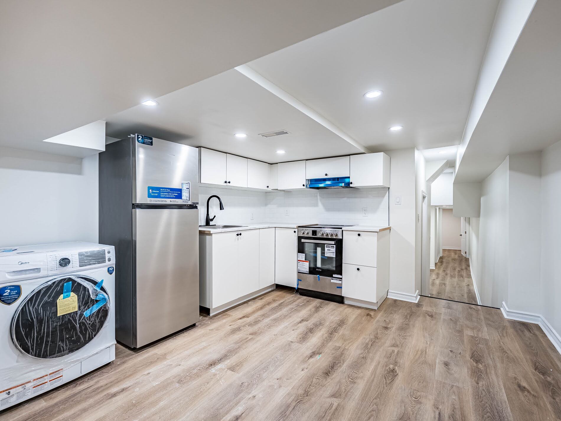 918 Ossington Ave fully renovated basement kitchen with L-shaped design.