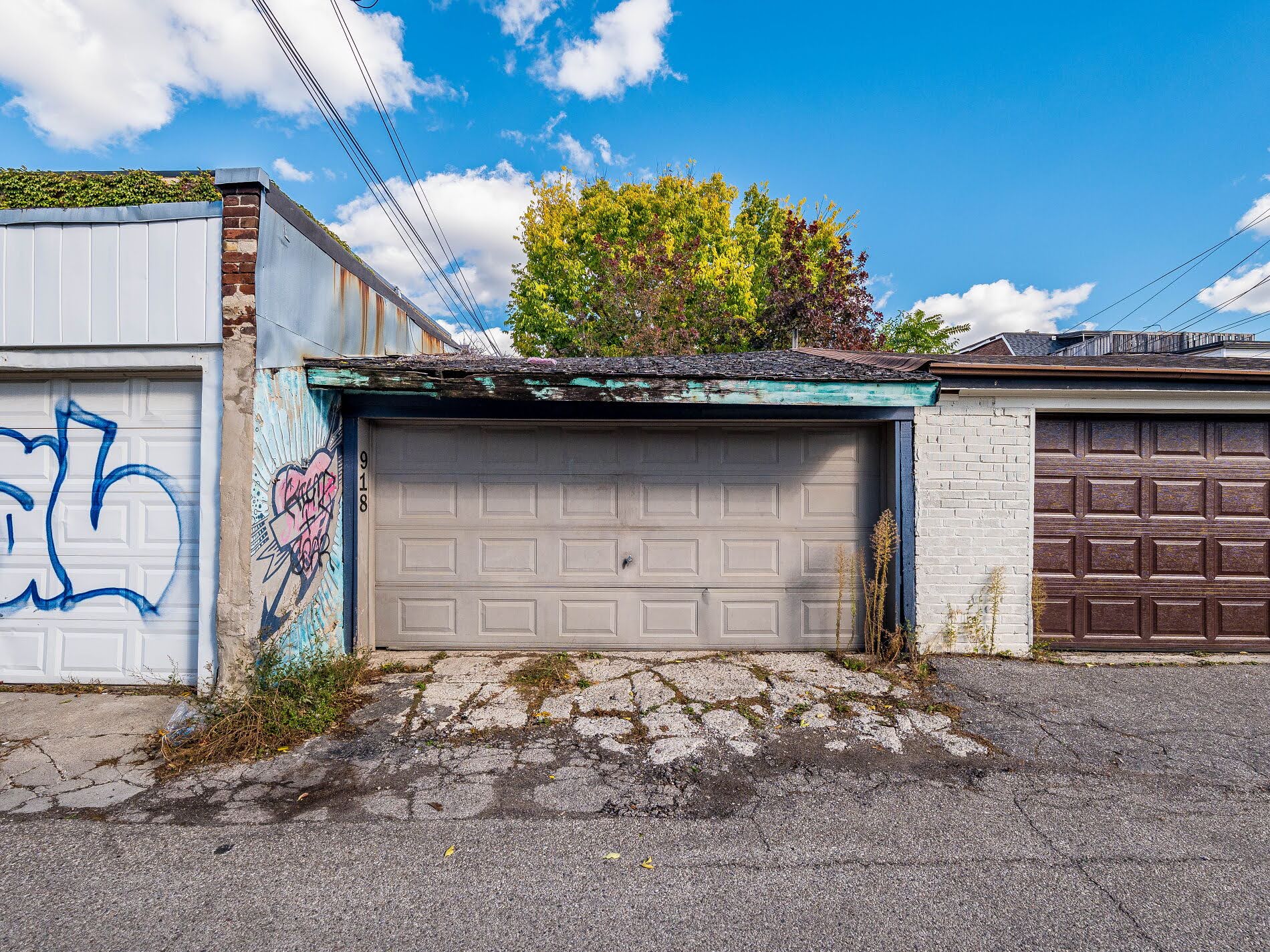 918 Ossington Ave beige door garage facing alleyway.