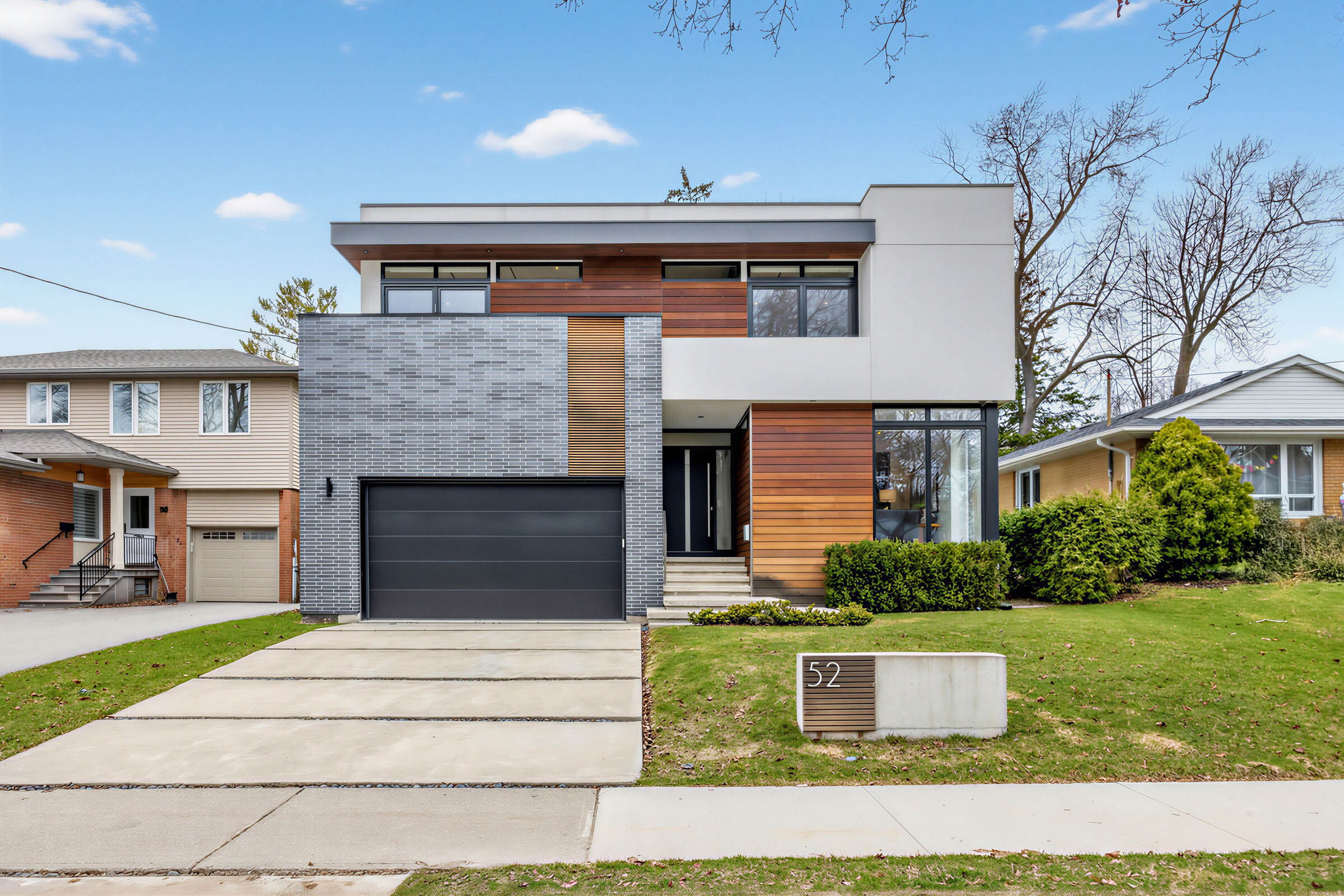 52 Burrows Ave modern, geometric facade showing house, driveway and lawn.