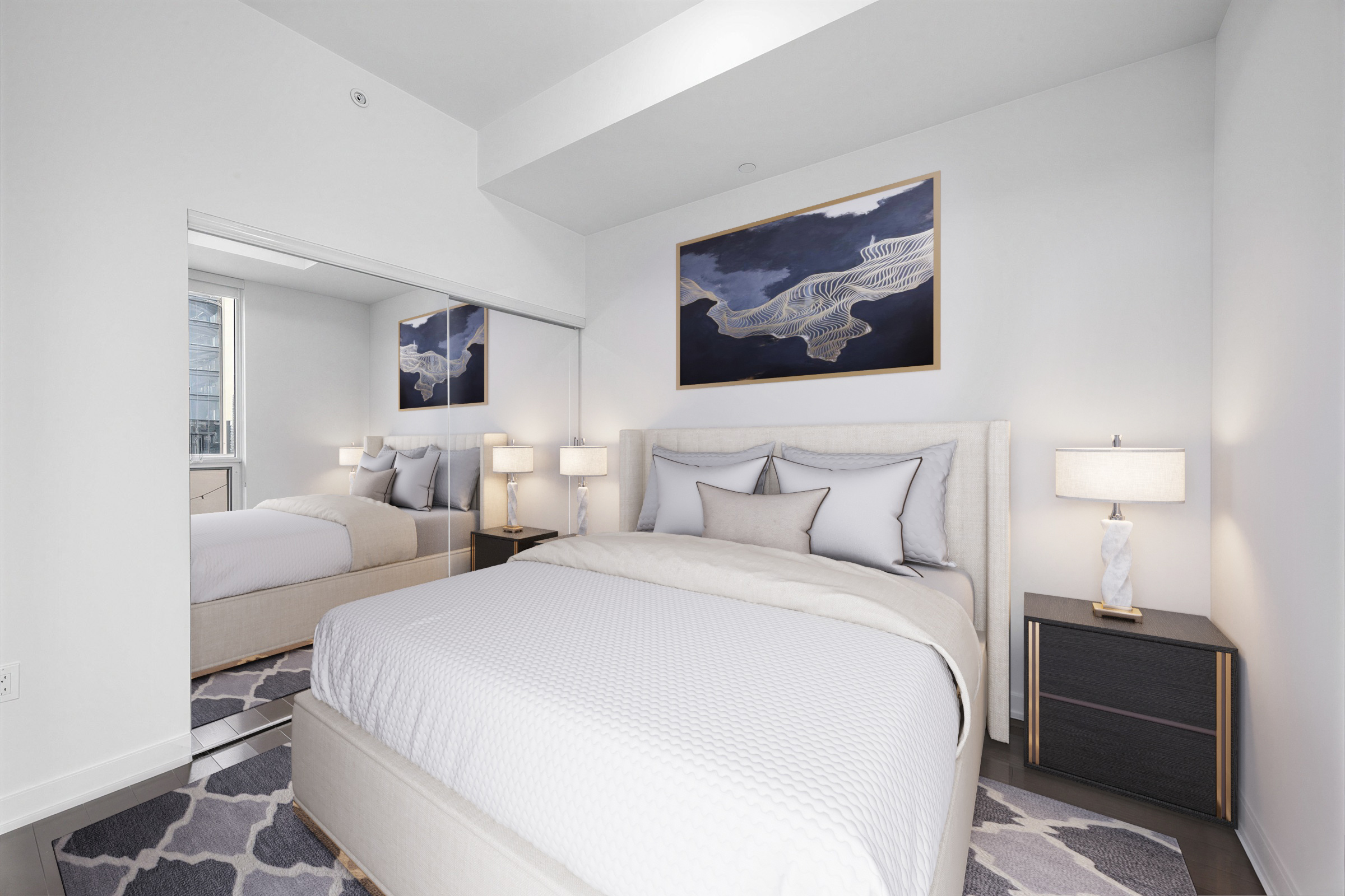 1 The Esplanade Unit 3403 large primary bedroom with bed, furniture, and double-door mirror closet.