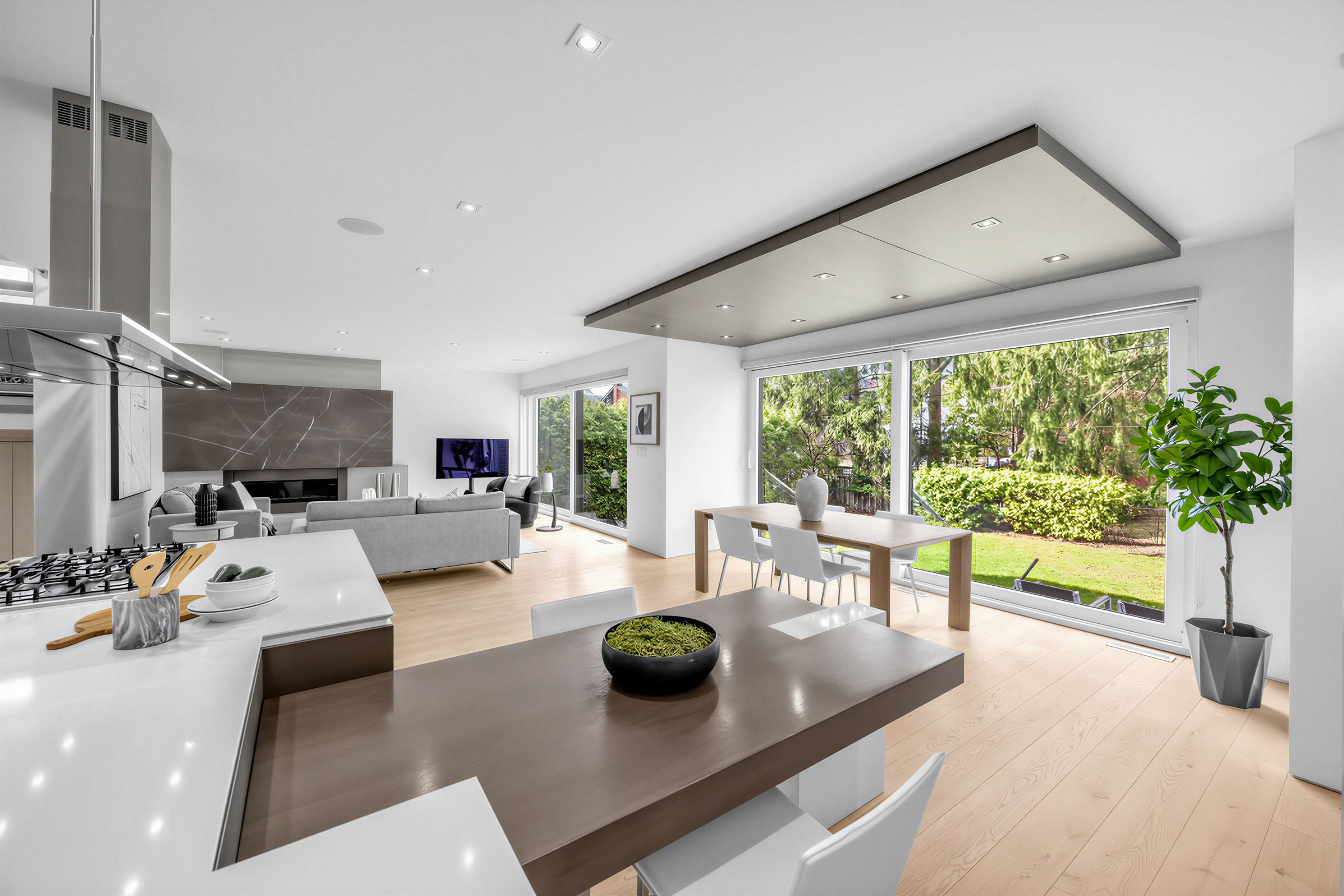 White kitchen island with dining brown peninsula table and 2 chairs.