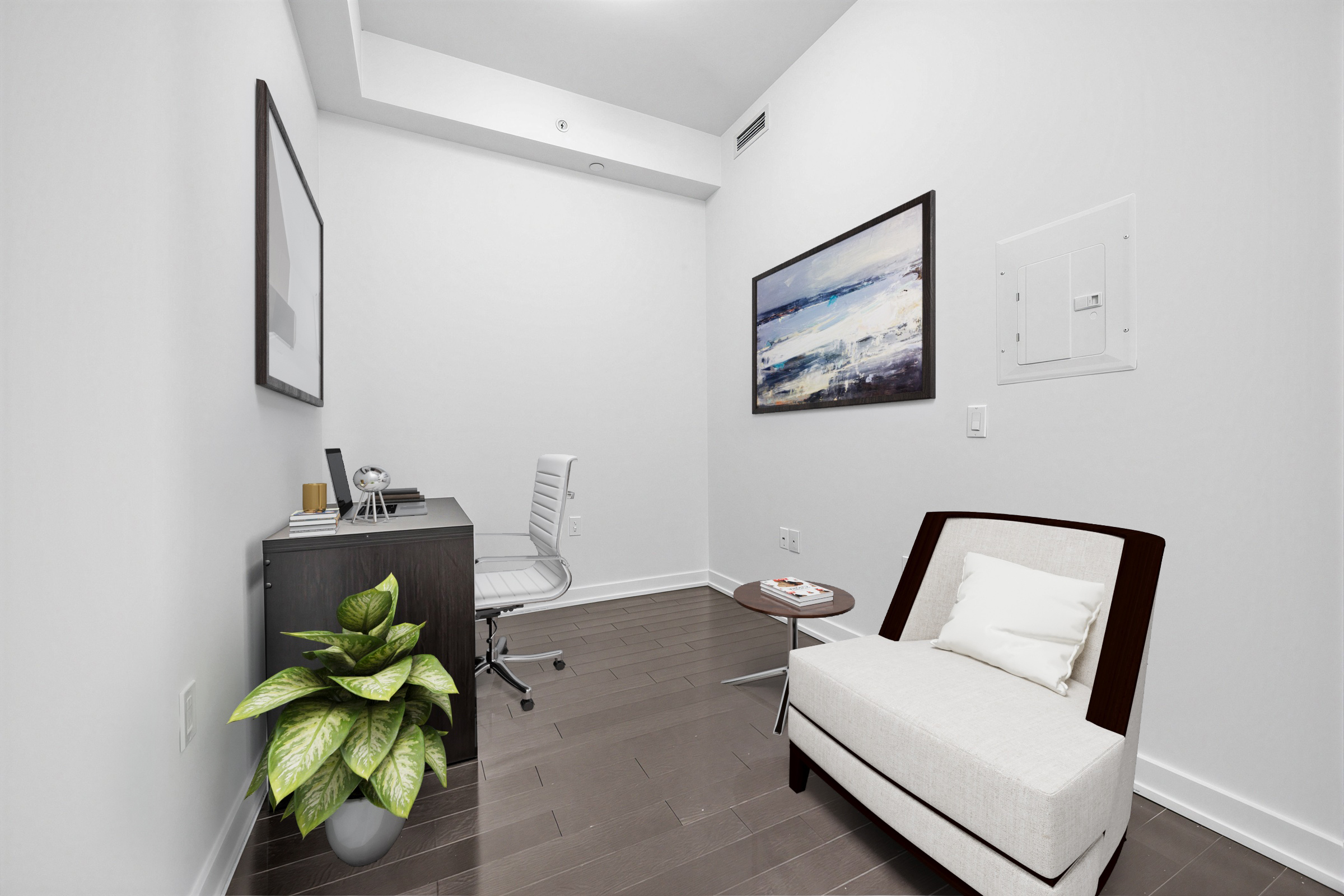 1 The Esplanade Unit 3403 den being used as home office with desk, chair, plant, table and art.
