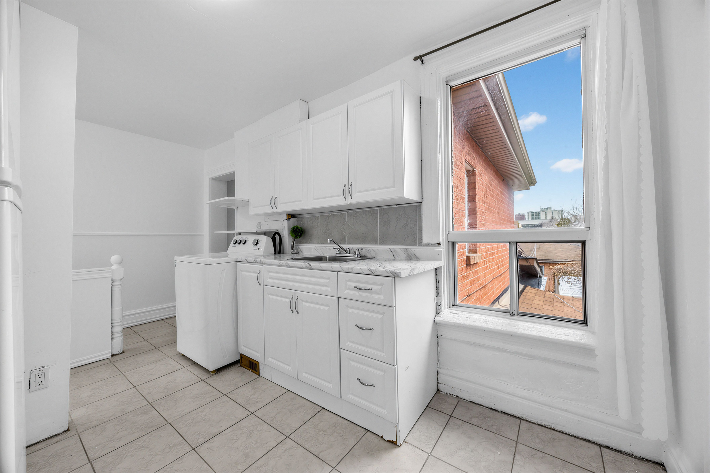 57 Shanly St second floor kitchen, laundry and large window.