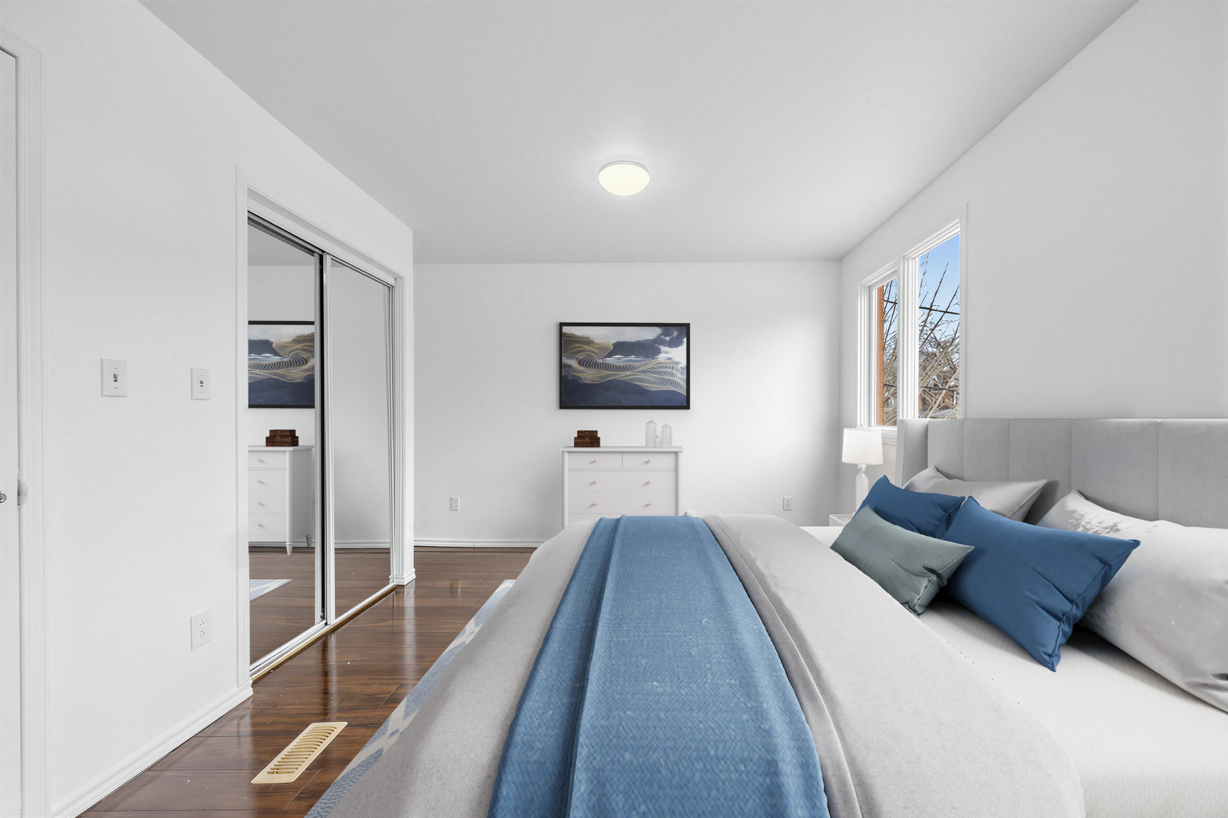 Bedroom with double-door mirror closet.