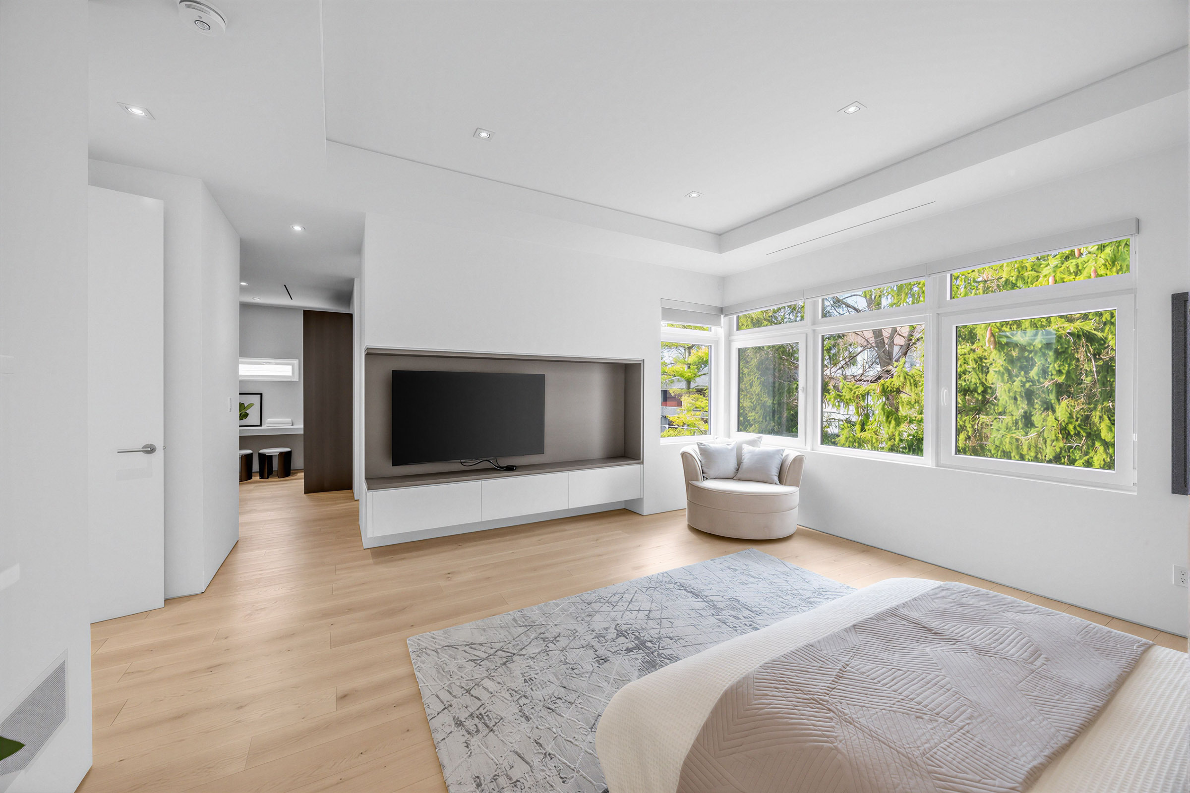 House bedroom with a recessed TV niche and floating cabinets.