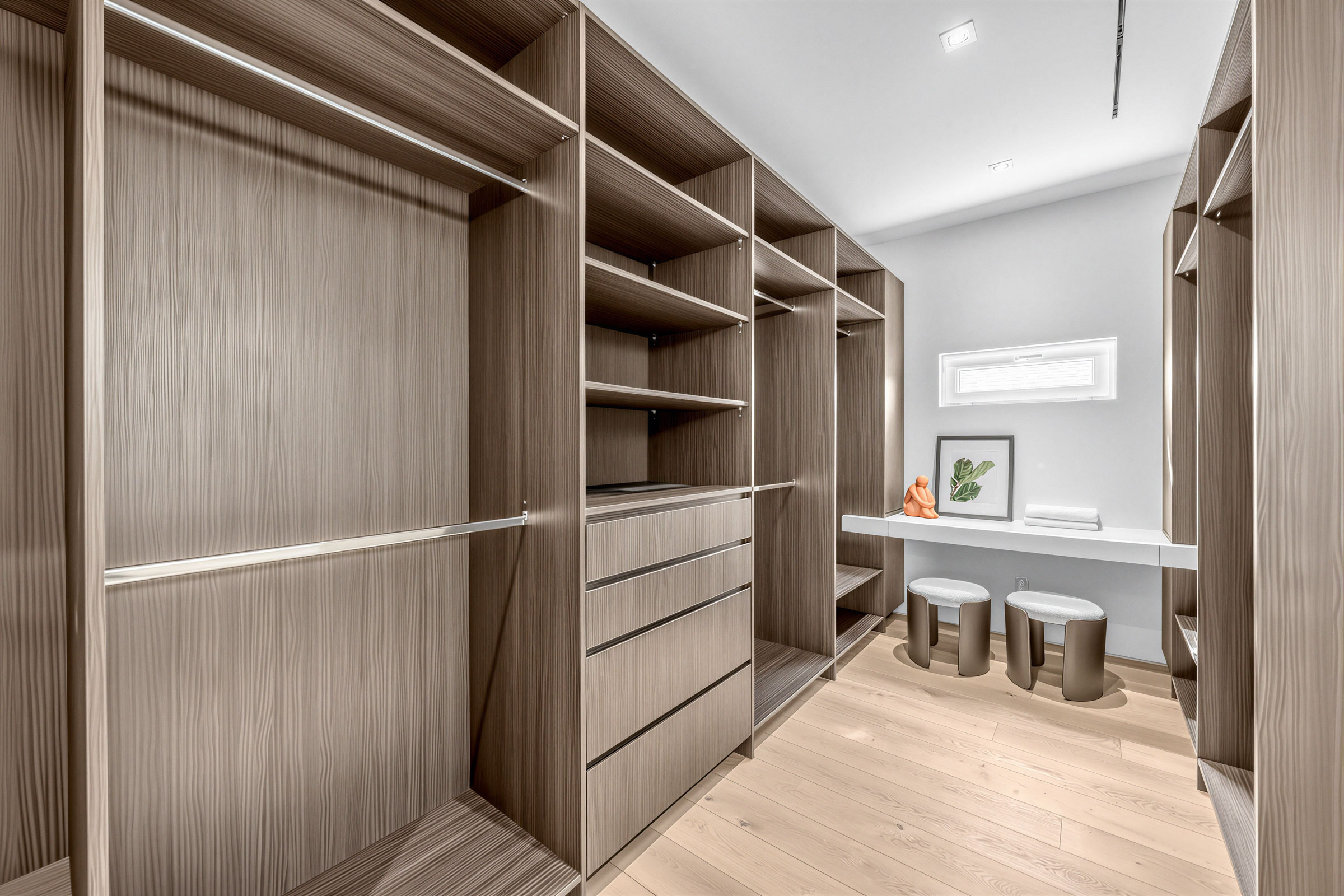 Large walk-in closet with floor-to-ceiling, wall-to-wall shelves and drawers.
