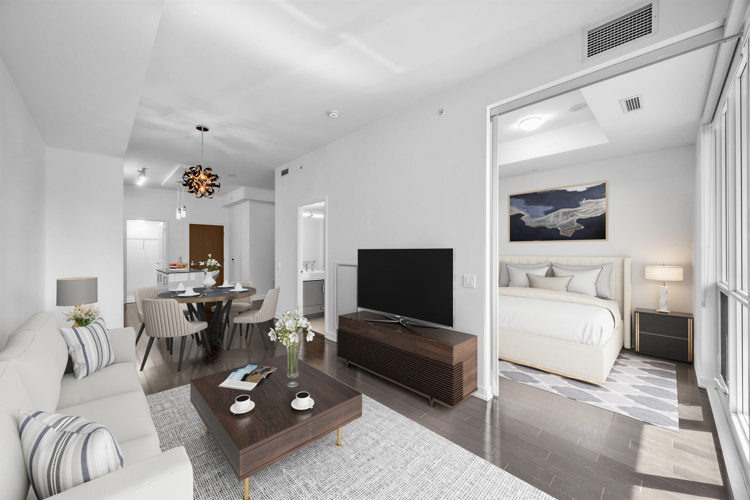 1 The Esplanade Unit 3403's newly painted, renovated living room with couch, carpet, coffee table, and TV stand.