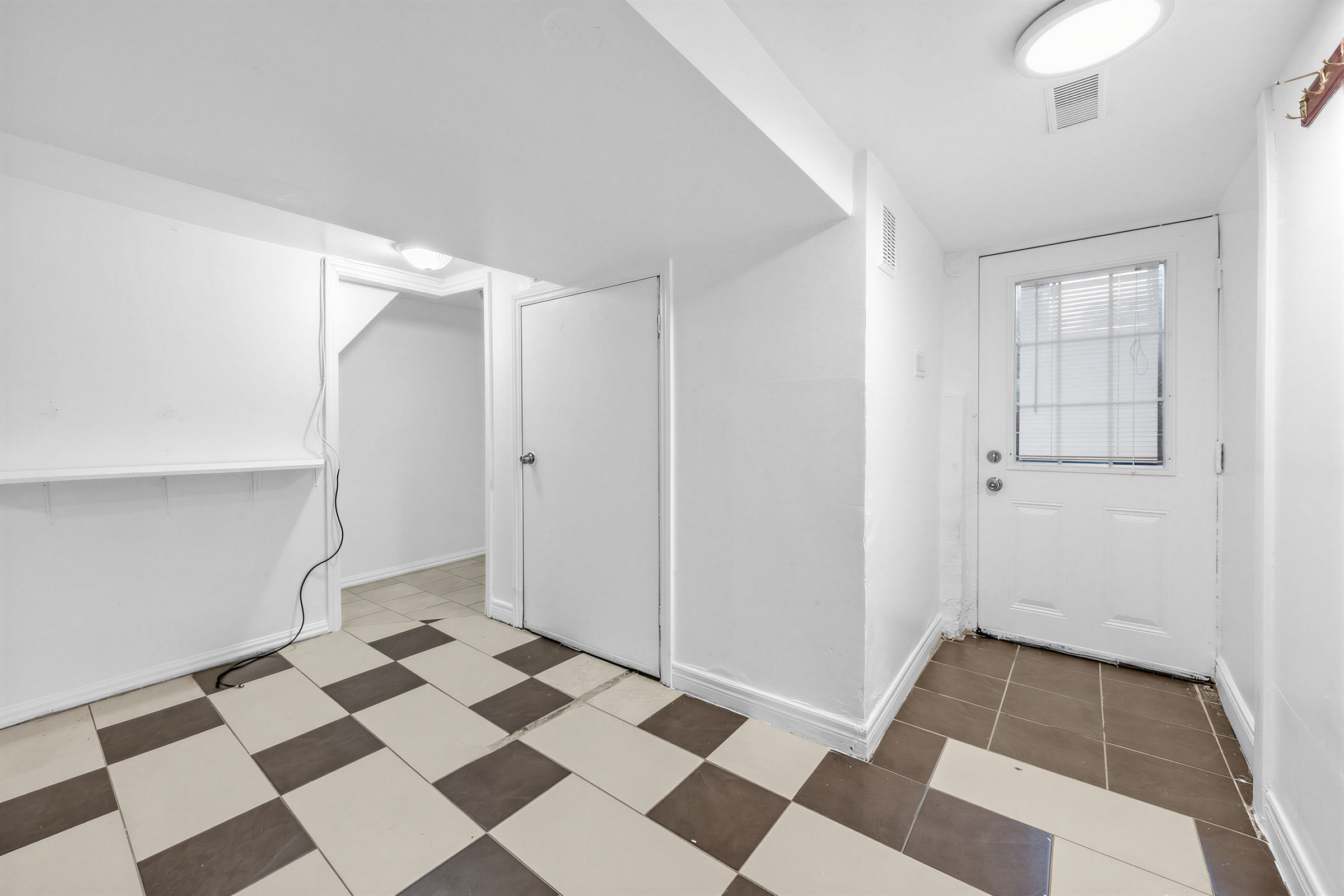 57 Shanly St basement entrance with checkered flooring.