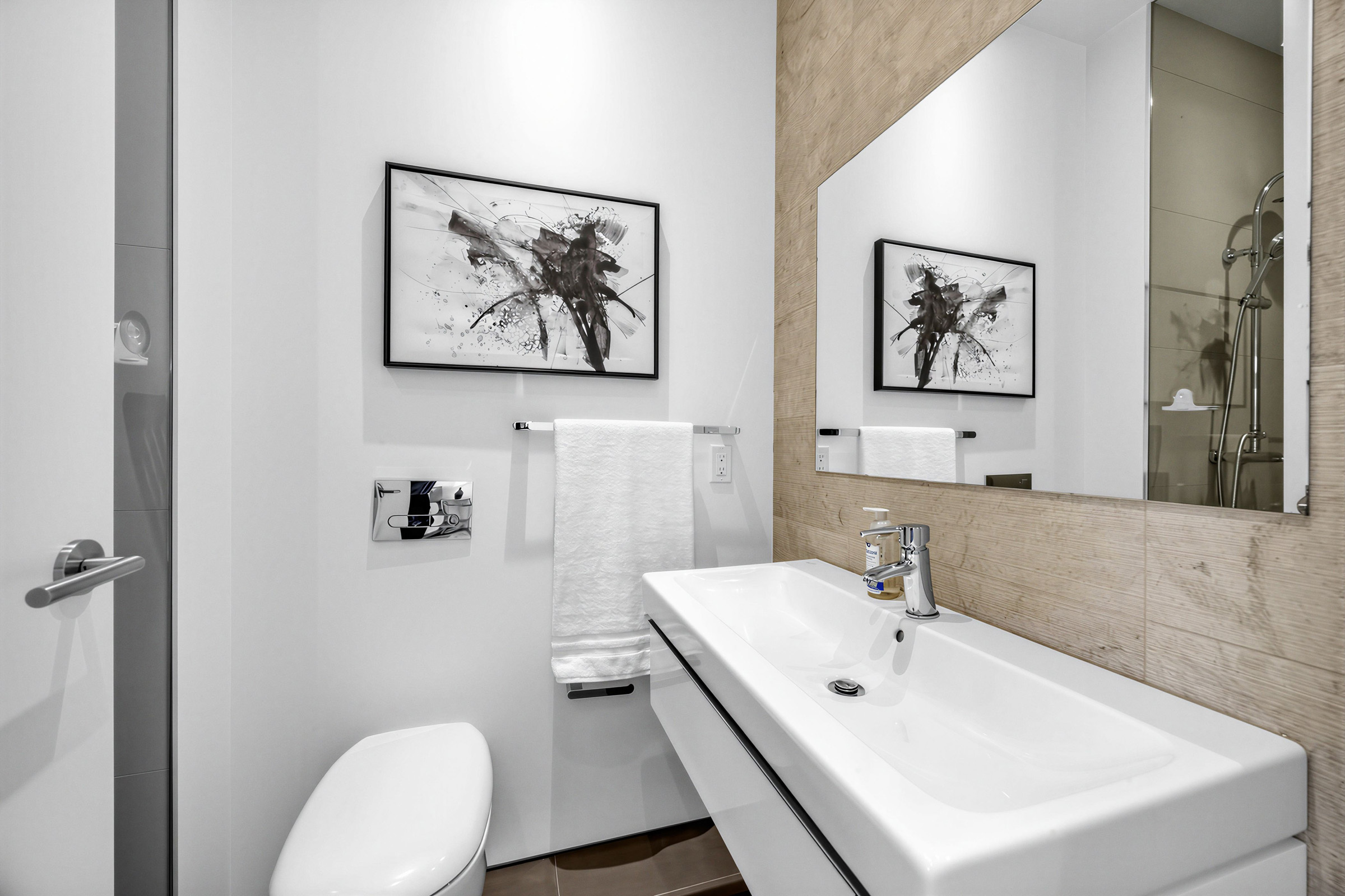 52 Burrows Ave 2nd bedroom 3-piece ensuite bath showing a floating sink with storage and square vanity.