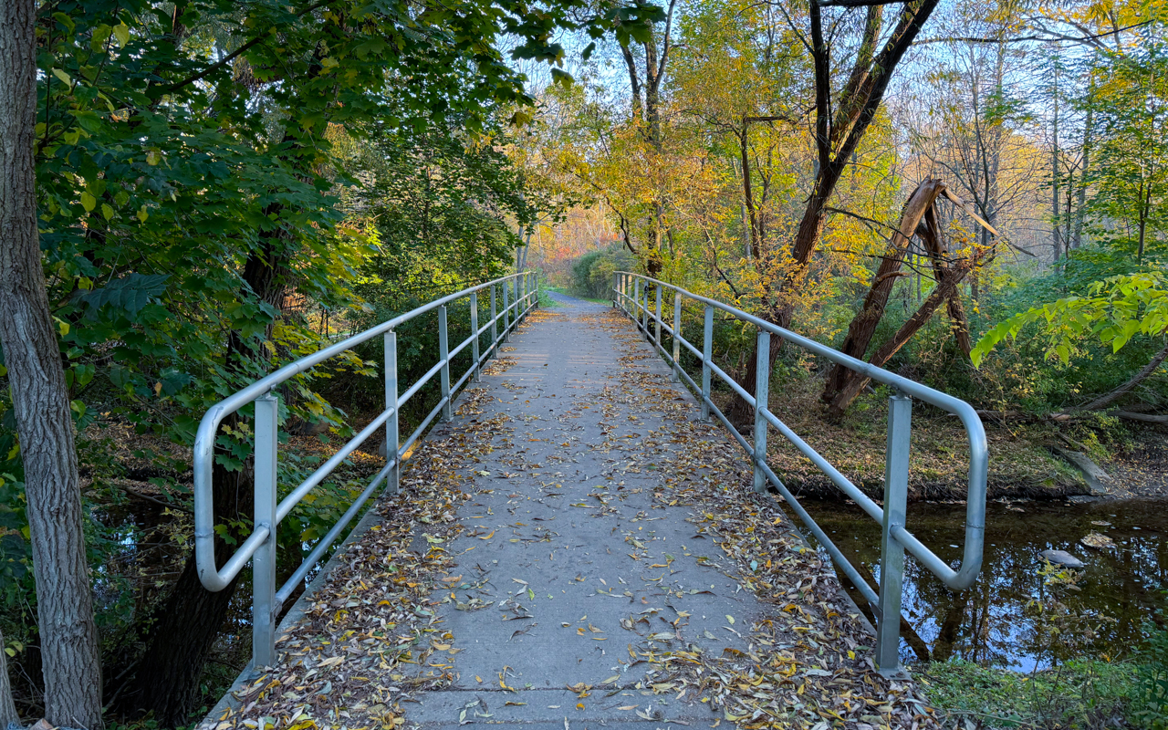 Bridge with rails over creek in Echo Valley Park in Toronto.