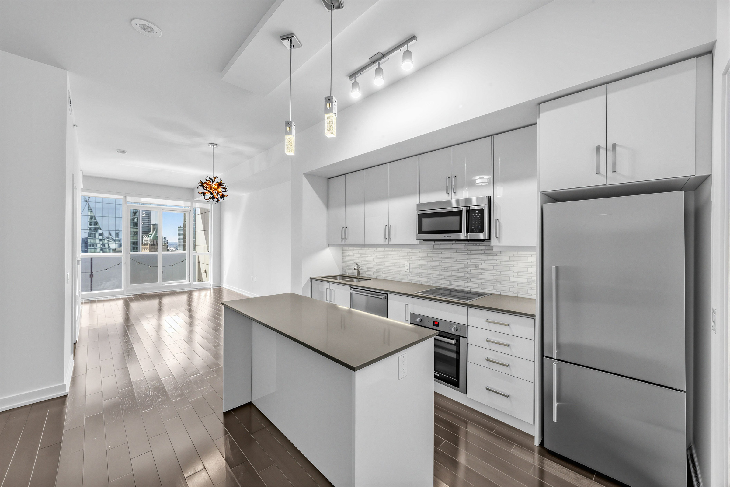 1 The Esplanade Unit 3403 kitchen lit by pendant, track and valence lights. 