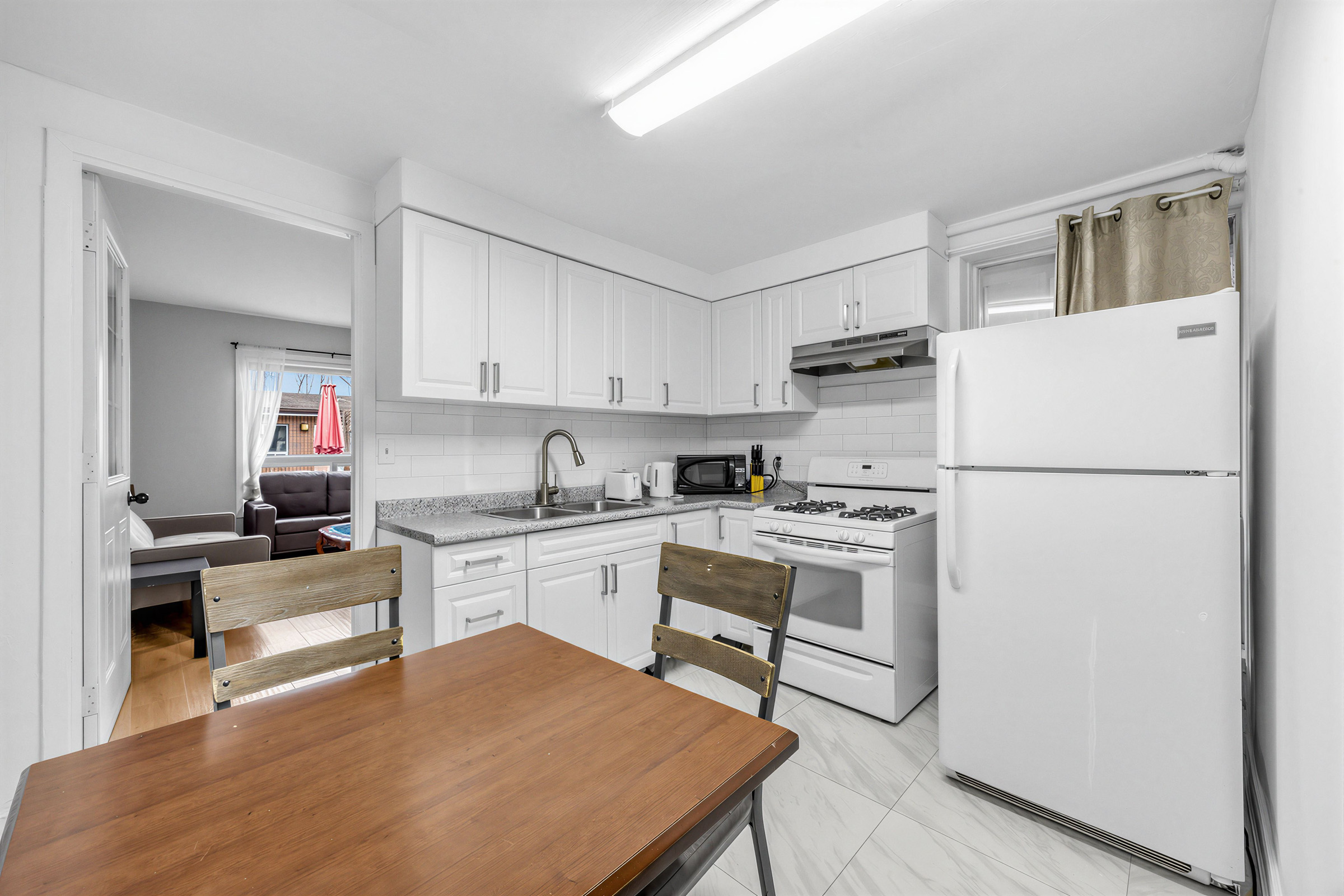 57 Shanly St kitchen and dining room with dining table in foreground and kitchen in background.