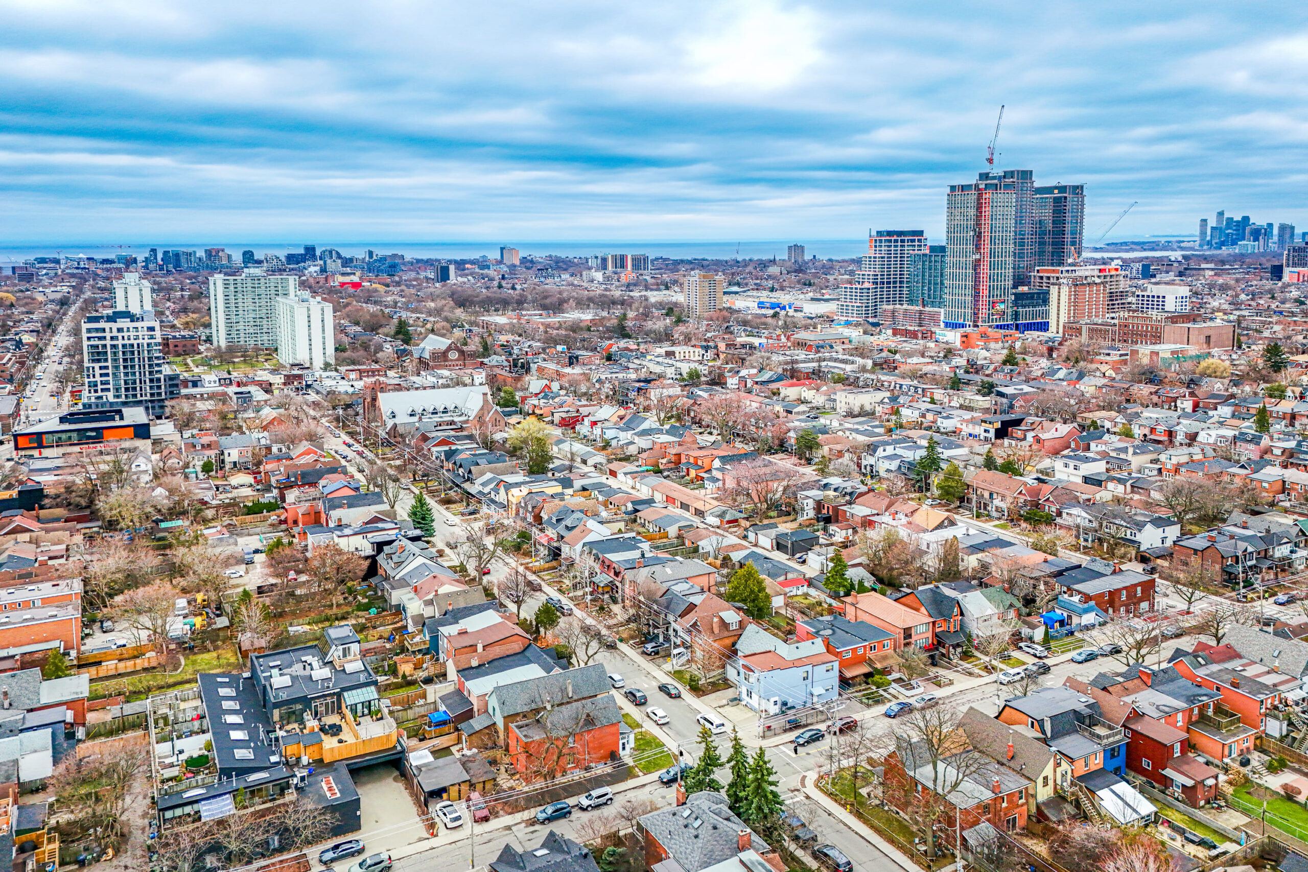 Aerial drone view of 57 Shanly St showing house, backyard, front yard, neighbouring houses, and streets with cars.