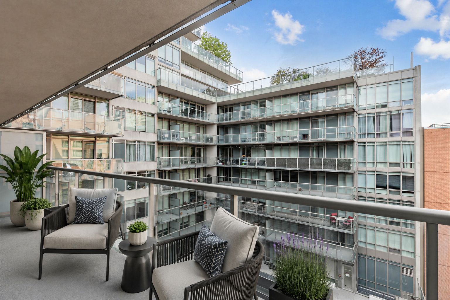 1 Bedford Rd Unit 603 balcony with 3D-rendered patio furniture and potted plants.