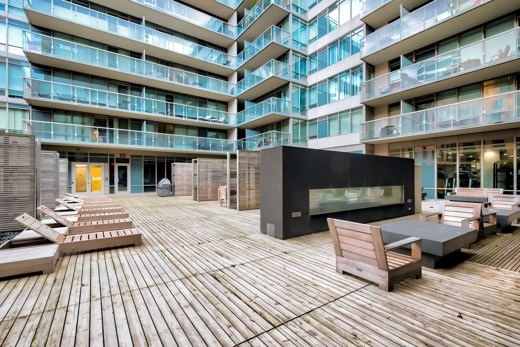 One Bedford condo's rooftop deck with fireplace and seating.