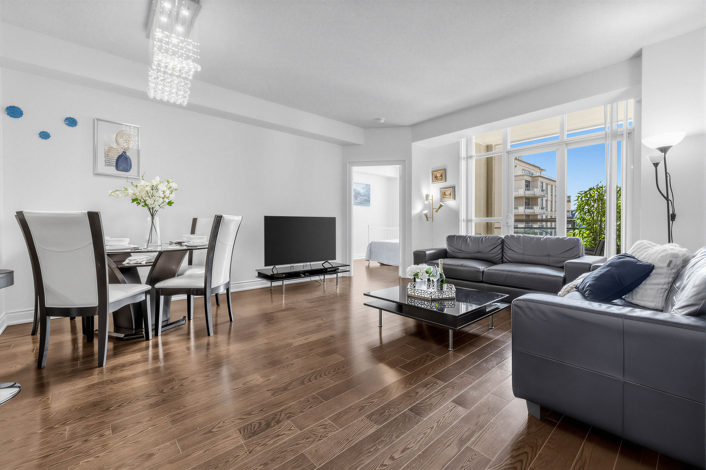 Open-concept living and dining areas with dark brown hardwood floors.