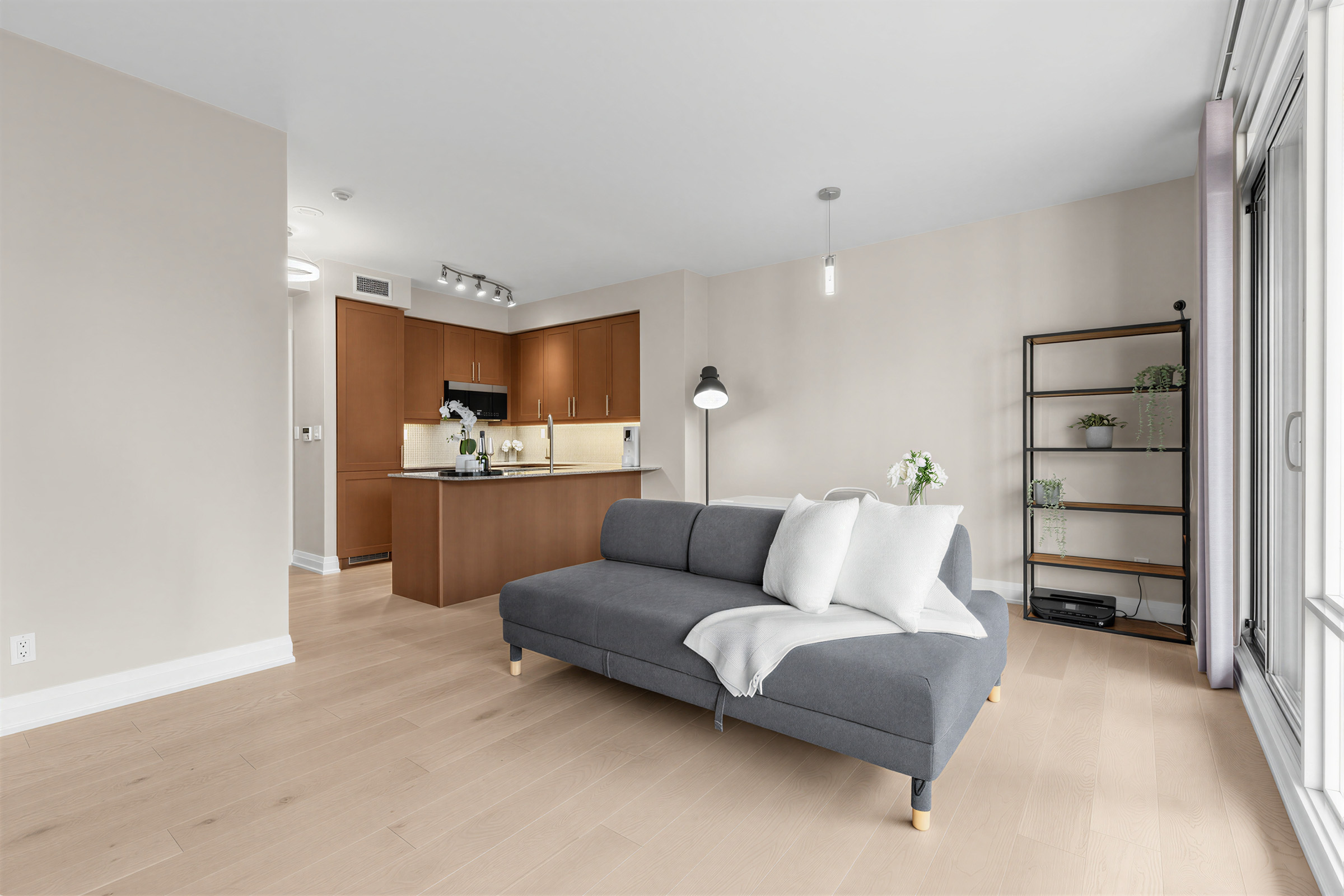 Condo living room with new wide plank White Oak DuraMatt hardwood floors.