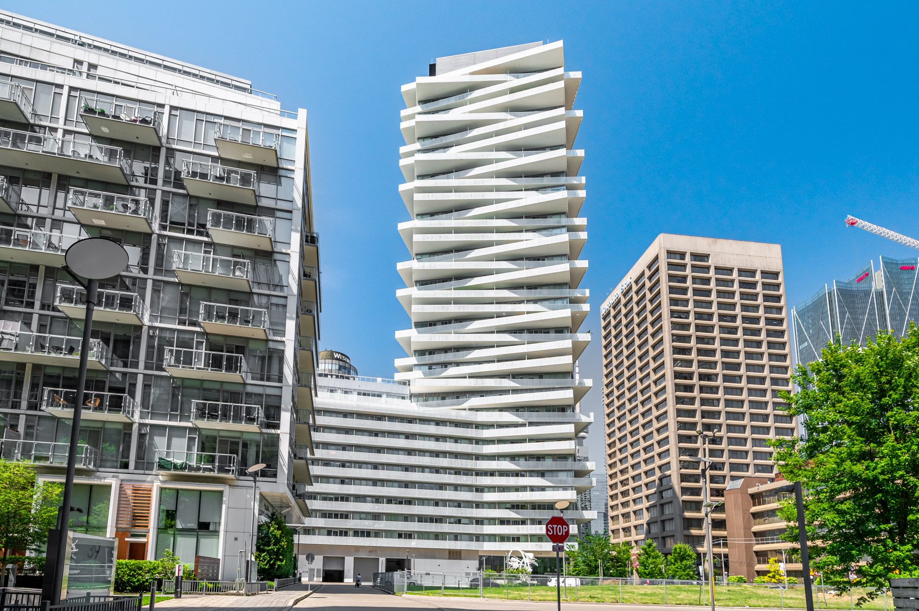 Pier 27 Condos with stacked, zig-zagging balconies and white concrete exterior.