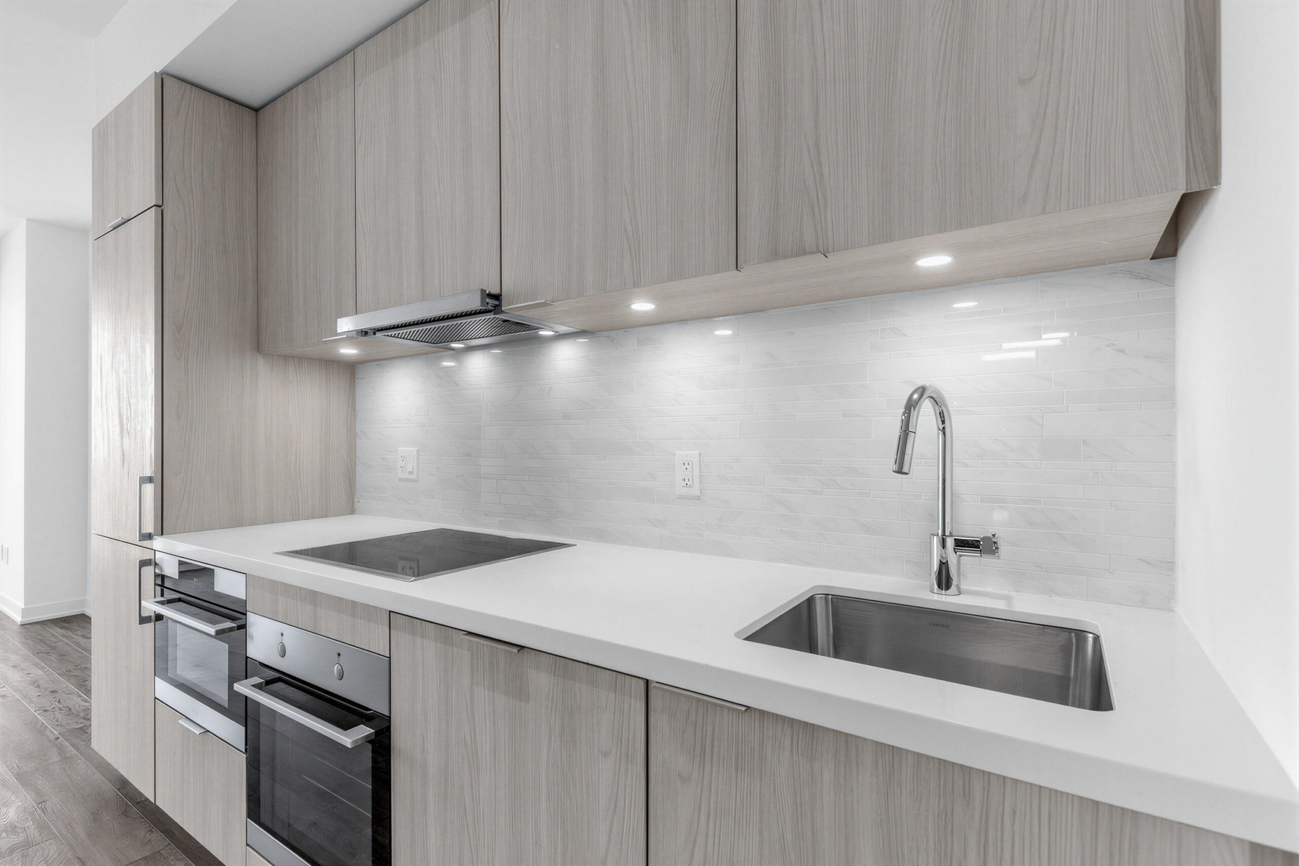 Close up of 15 Queens Quay E Unit 1901 kitchen's backsplash and cabinetry.